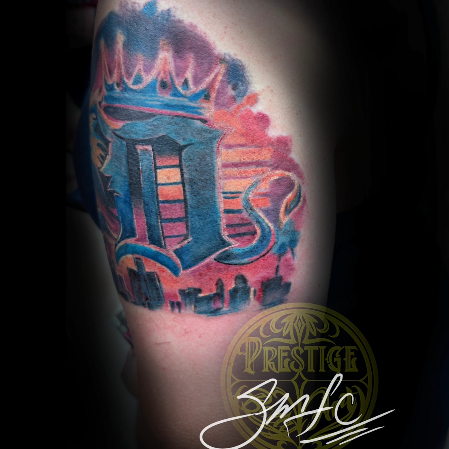 Cityscape with crown watercolor tattoo on the forearm by Shawn Cook