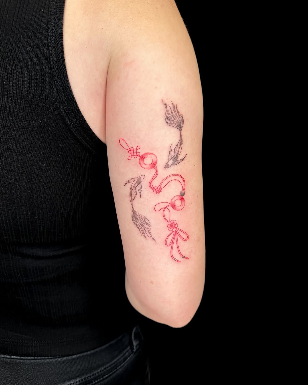 Koi fish and red string minimalist tattoo on the forearm by INK by CEE