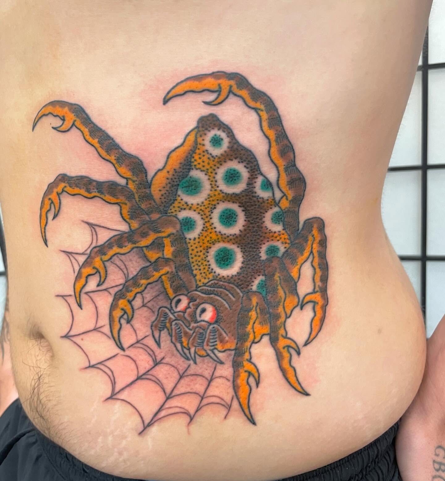 Spider dotwork tattoo on the torso by Seth Griffin