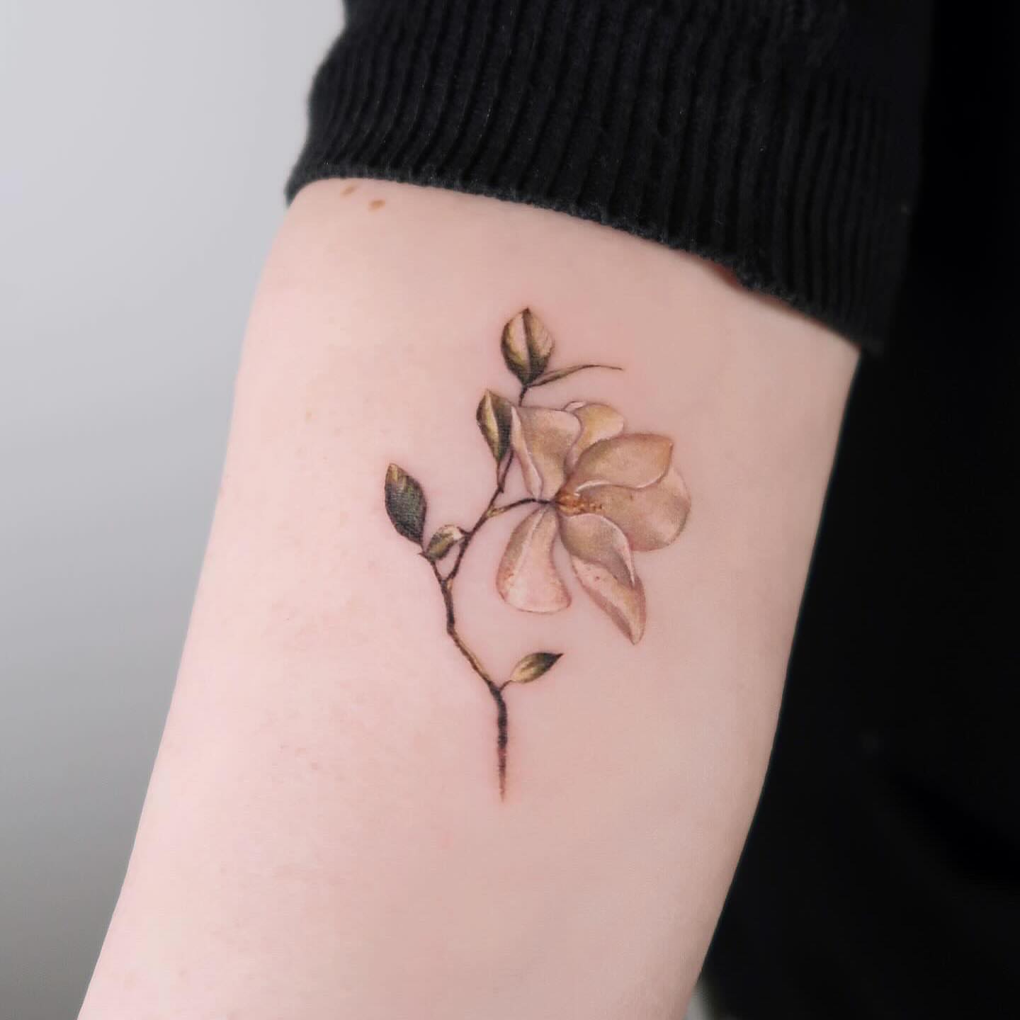 Flower bud realism tattoo on the forearm by Alissa Jung