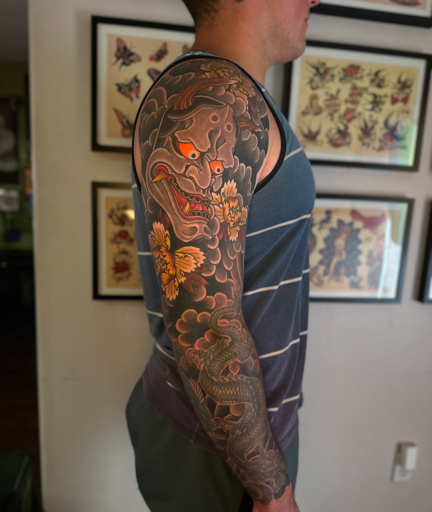 Demon mask and dragon japanese irezumi tattoo on the upper arm by Kenny Waizumi ๐