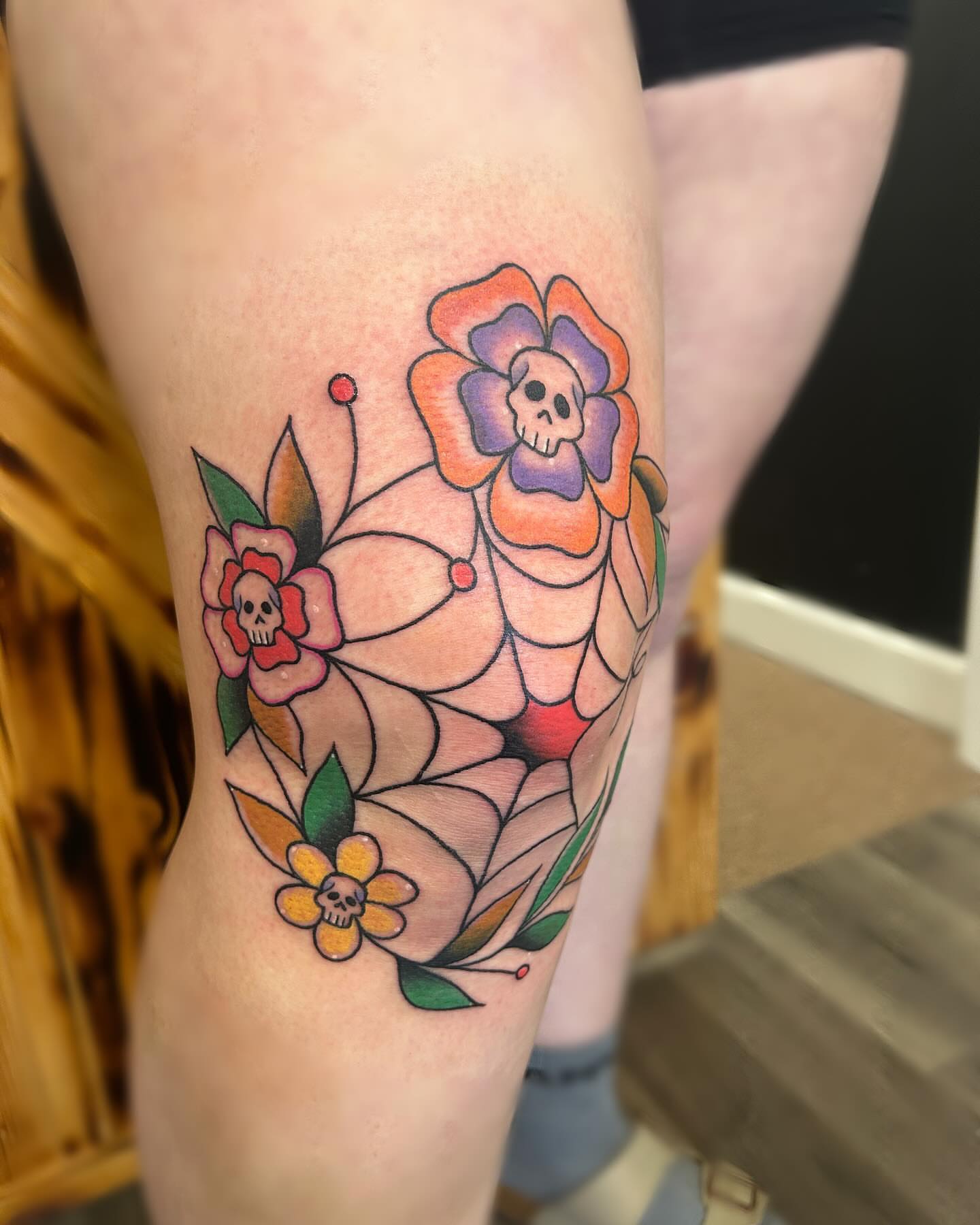 Floral arrangement with skulls American traditional tattoo on the thigh by ππππππ ππππππ