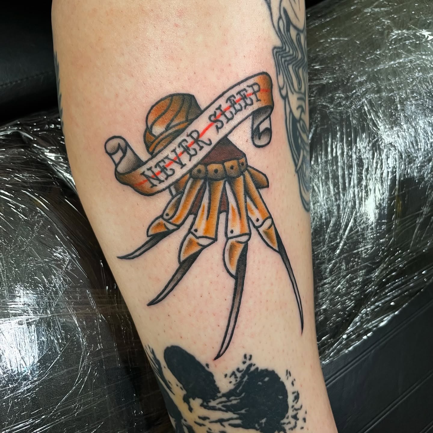 Octopus with banner American traditional tattoo on the forearm by Dyllan Shipley