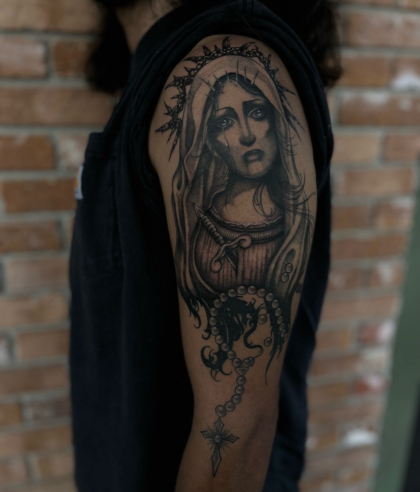 Religious figure realism tattoo on the upper arm by Myla Jane, Houston, Texas