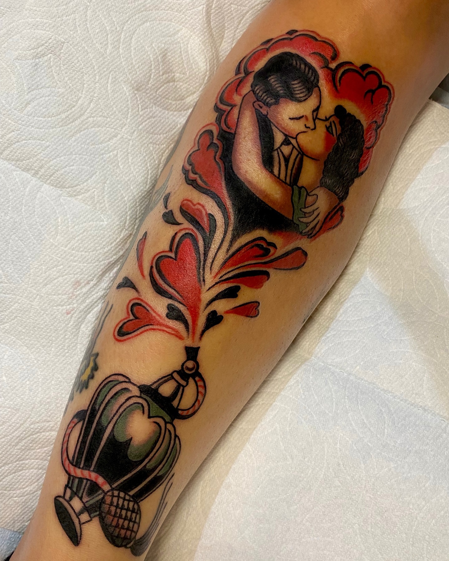 Kissing couple American traditional tattoo on the forearm by Haley Tucker, Sebastopol, California