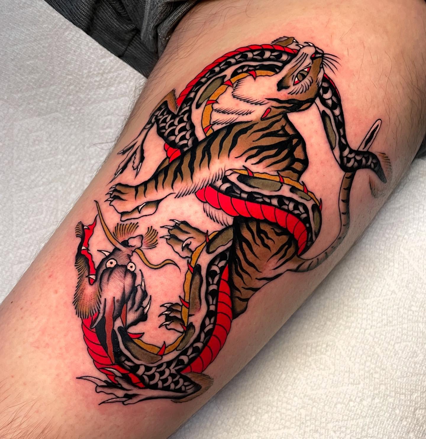 Dragon and tiger American traditional tattoo on the forearm by Toulouse Noble, Portland, Oregon