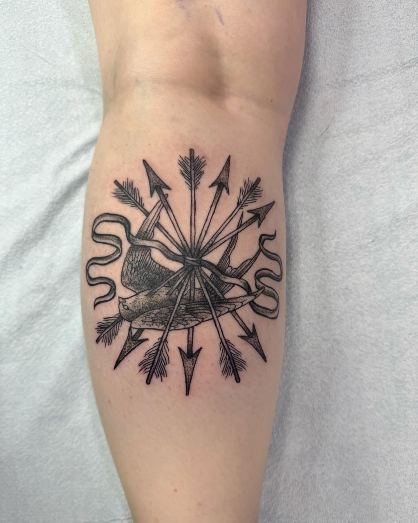 Heart with arrows black and grey tattoo on the forearm by Marissa Losier
