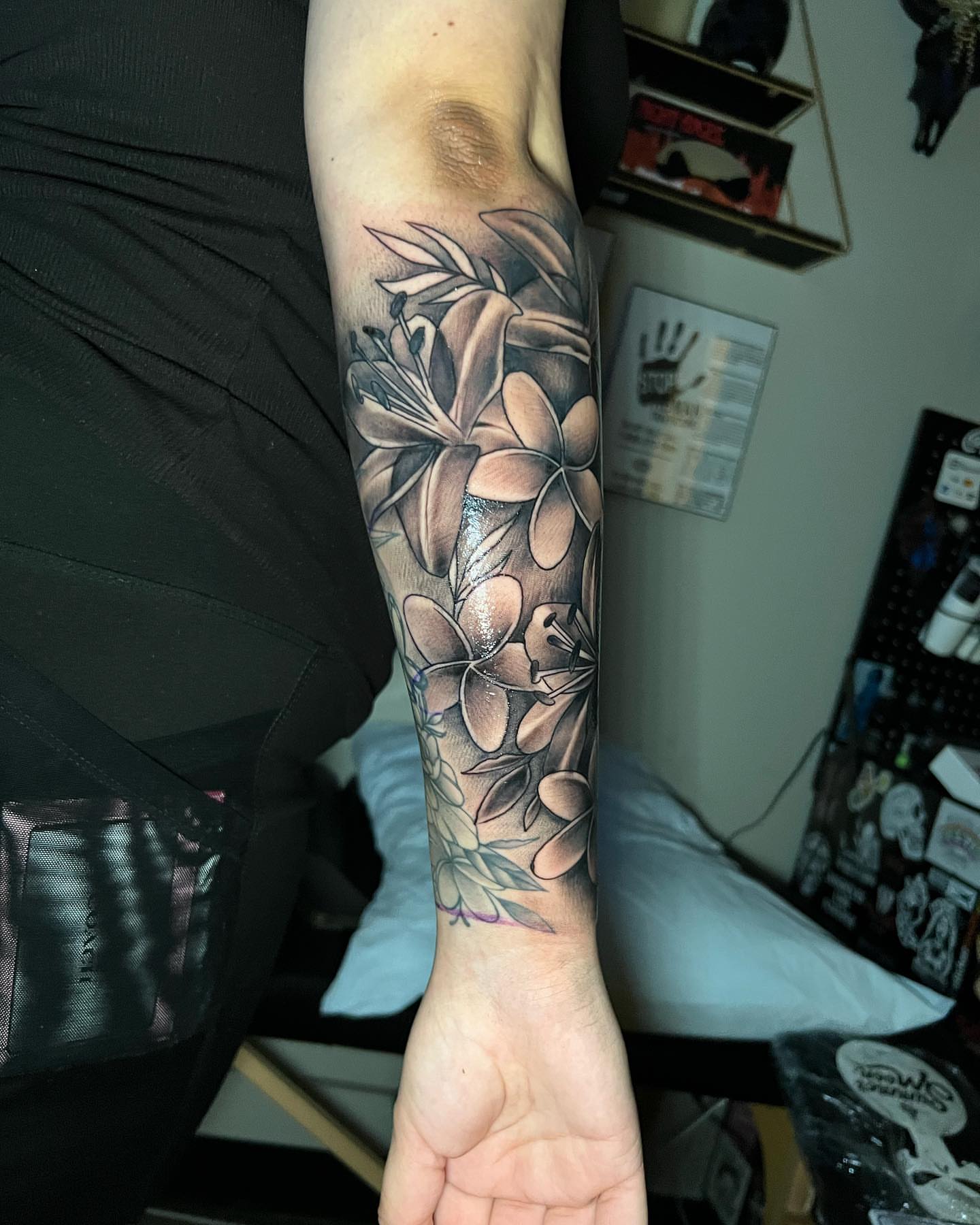 Flowers black and grey tattoo on the forearm by Matthew Arguello