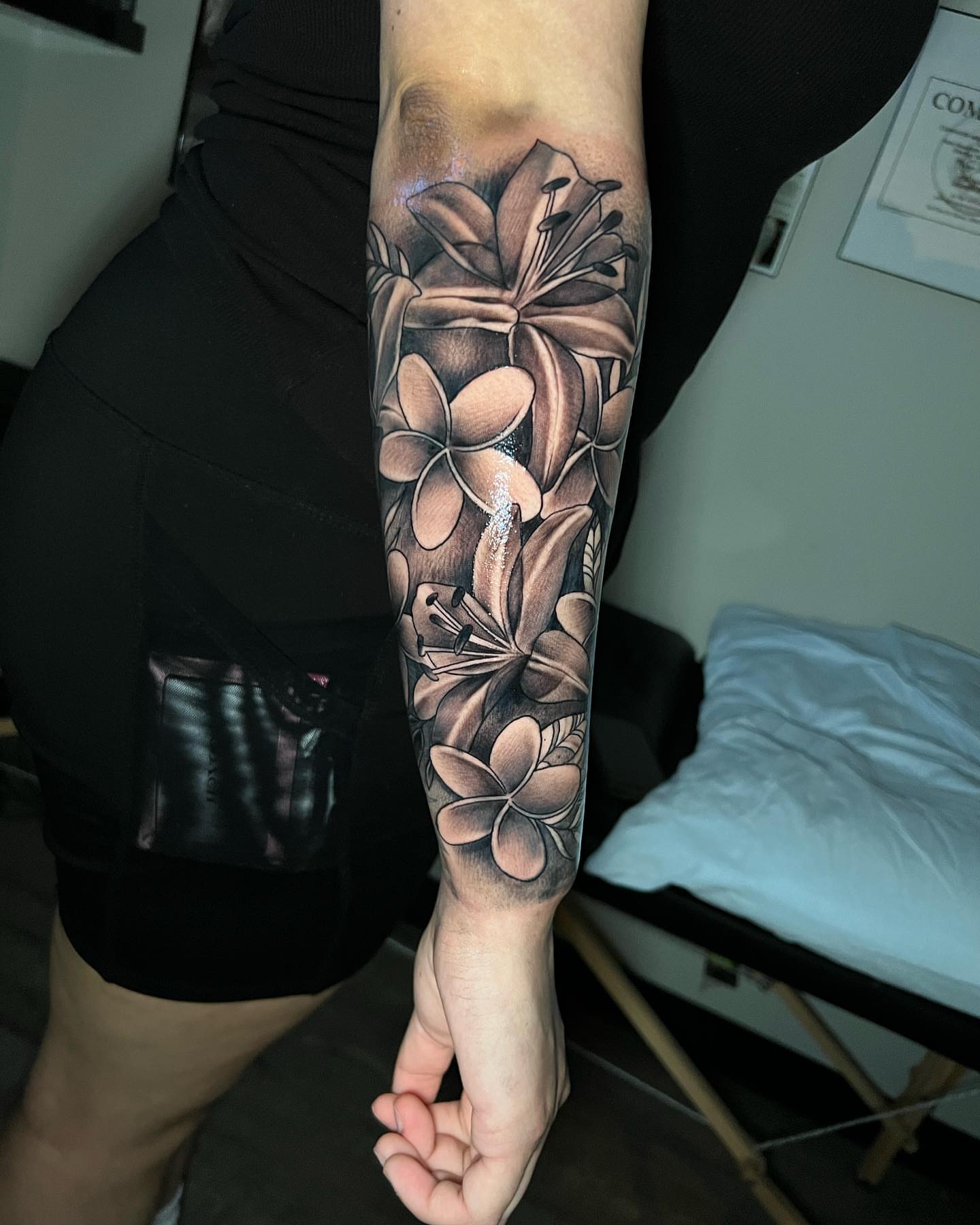 Flowers black and grey tattoo on the forearm by Matthew Arguello