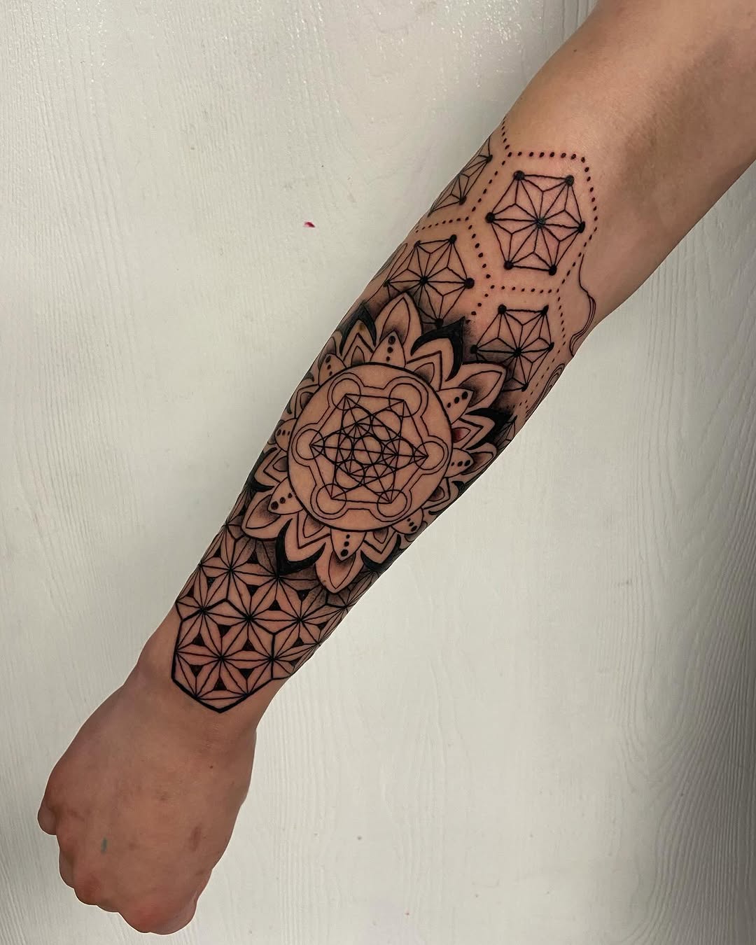 Geometric mandala ornamental tattoo on the forearm by Sophia