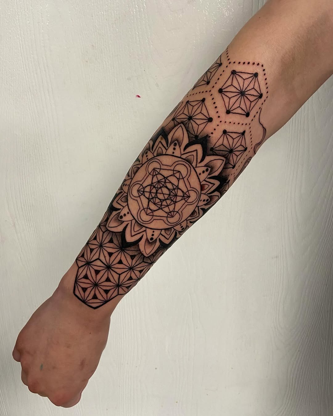 Geometric mandala ornamental tattoo on the forearm by Sophia