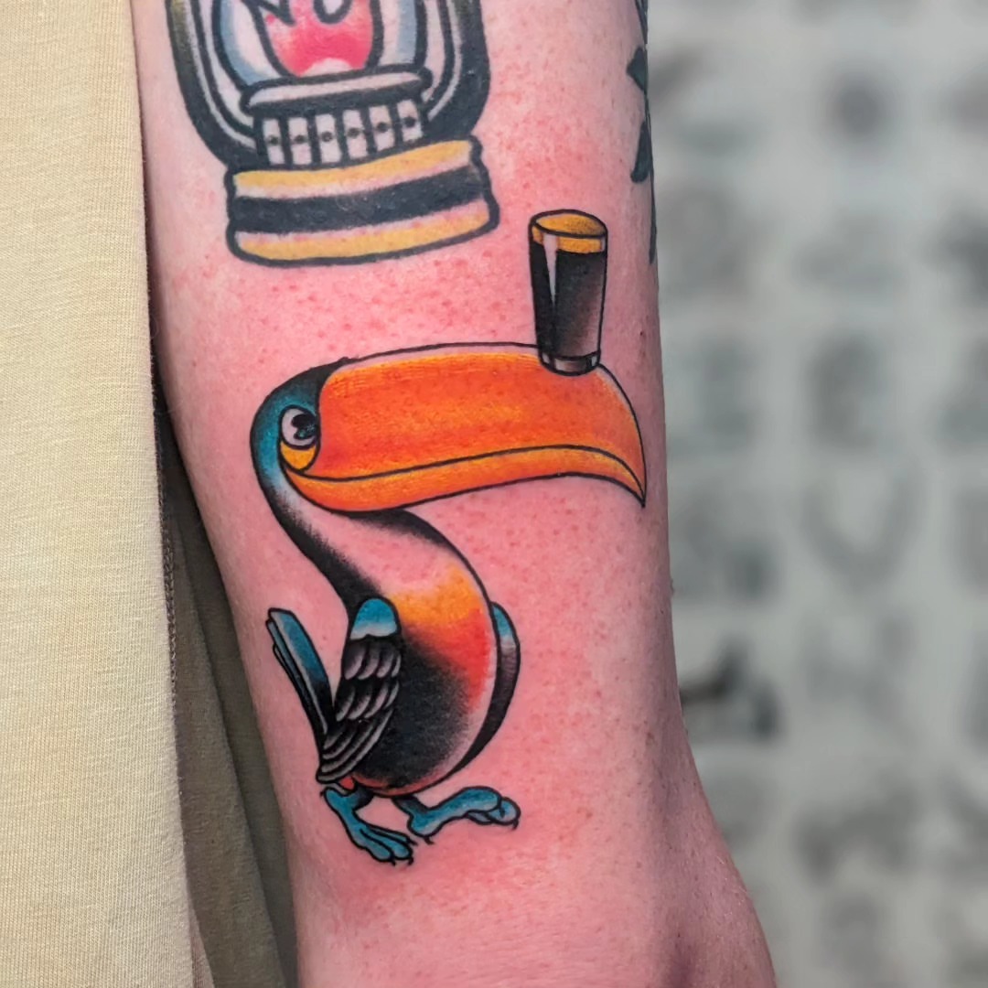 Toucan American traditional tattoo on the forearm by Matt Simmonds