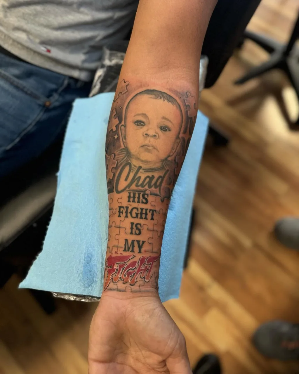 Baby portrait realism tattoo on the forearm by Eldaddy