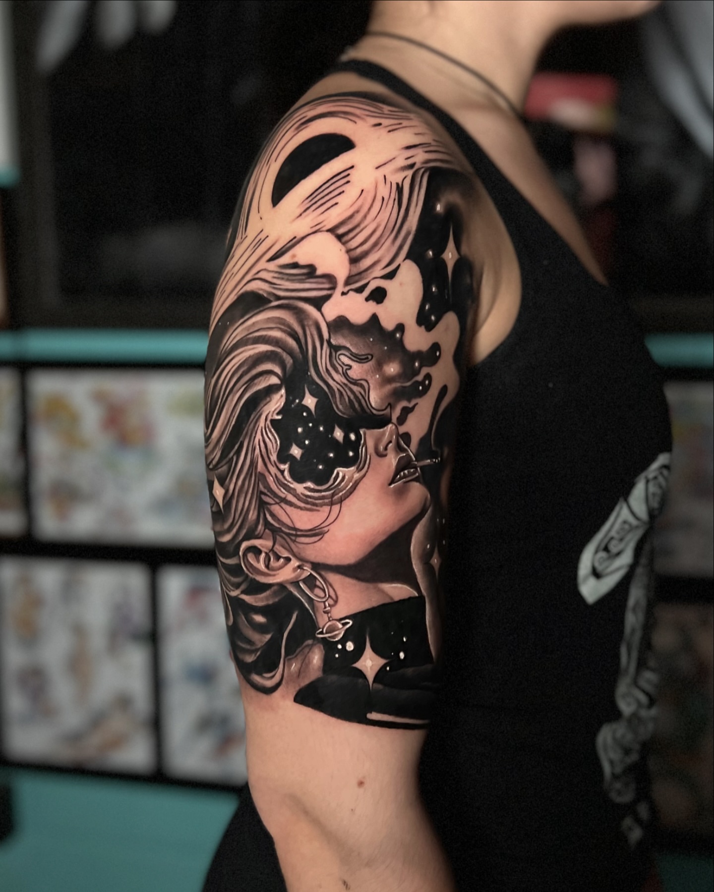 Woman with celestial elements realism tattoo on the upper arm by Sebastian Calderon