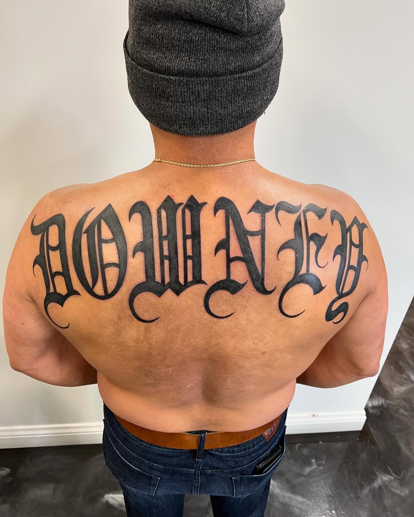 Script lettering lettering script tattoo on the back by San Diego Fineline Black & Grey Tattoo Artist
