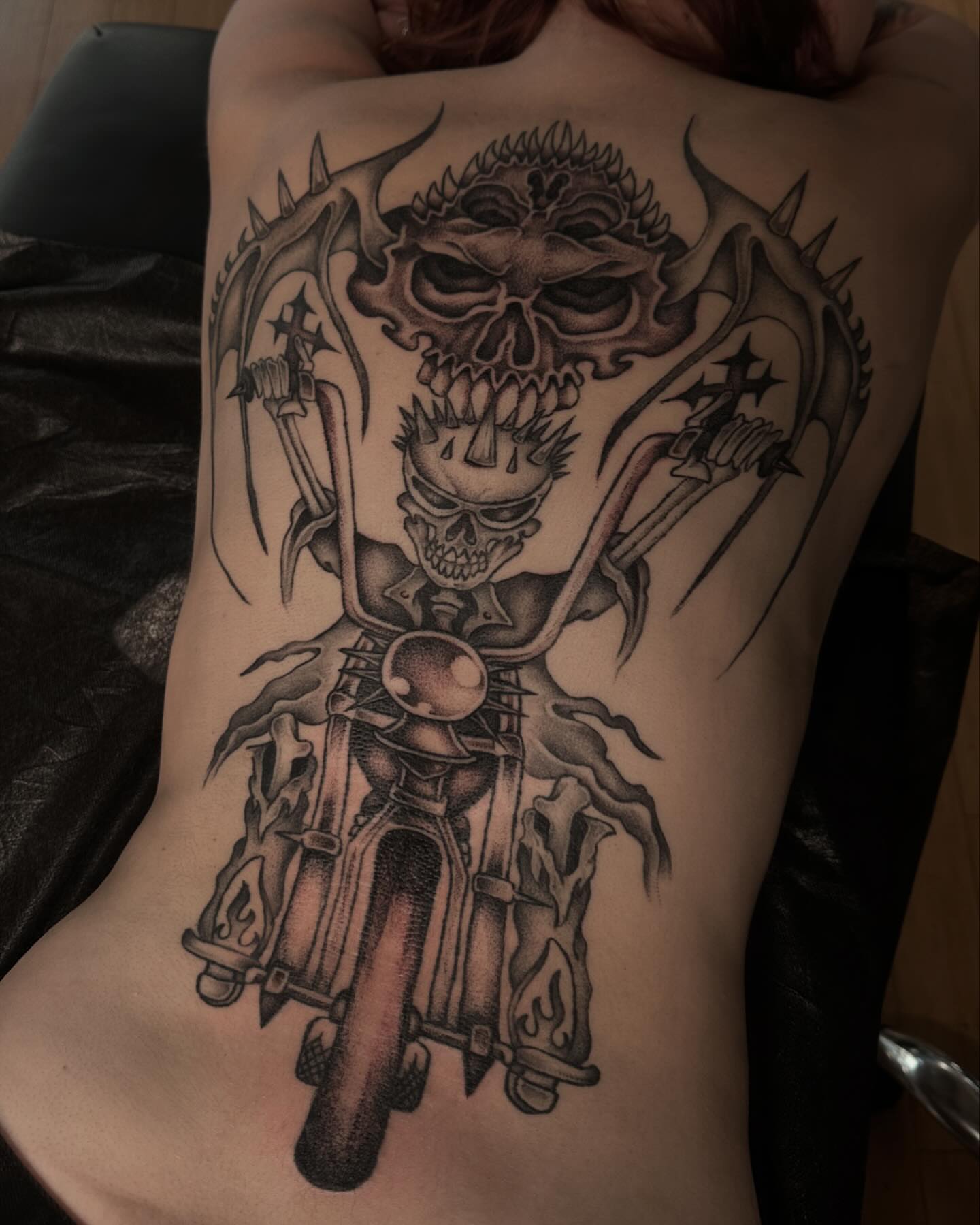 Motorcycle rider with skulls dark realism tattoo on the back by 𝖍𝖆𝖓𝖓𝖆𝖍