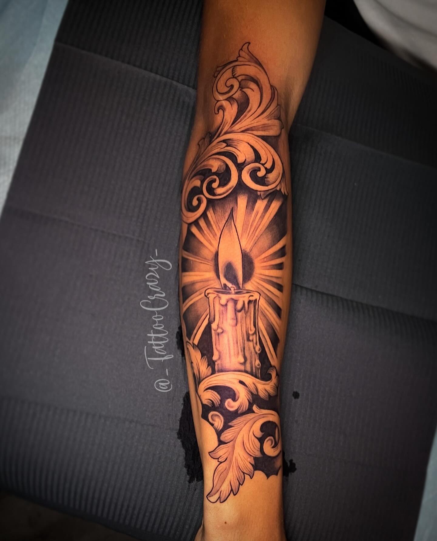 Candle and ornate scrollwork realism tattoo on the forearm by TattooCrazy🎭