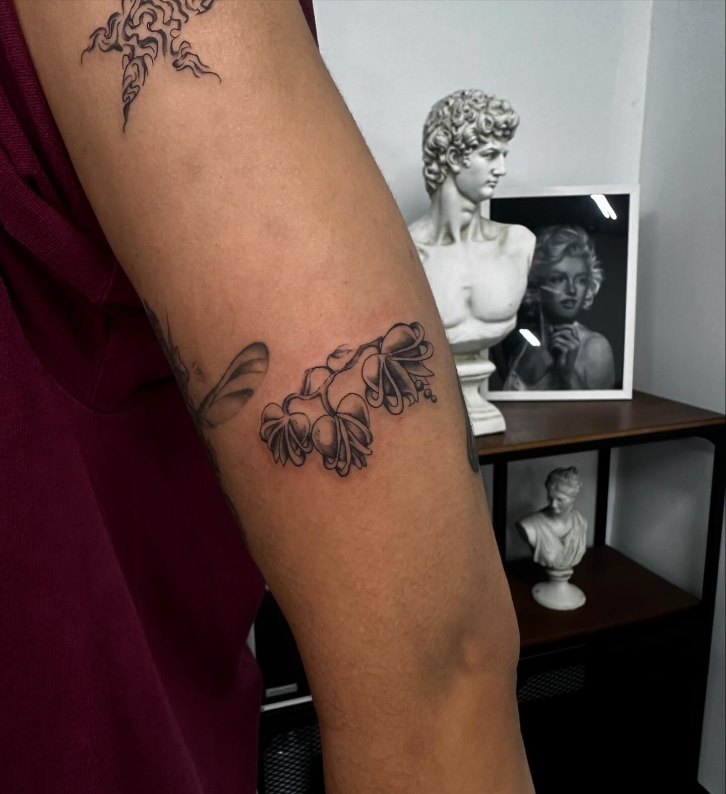 Bell flowers black and grey tattoo on the forearm by chloe🗡️🖤🦇🩸