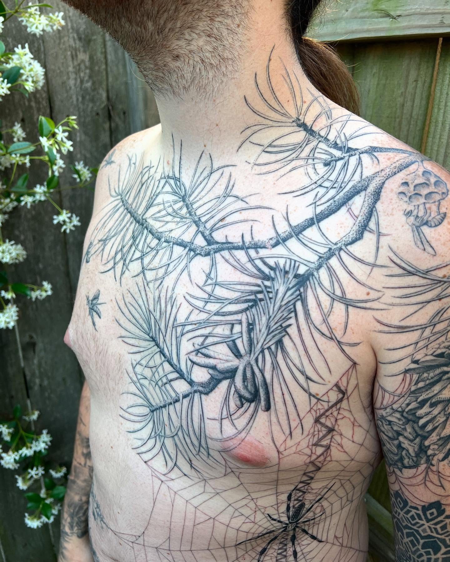 Pine branch realism tattoo on the chest by Natasha