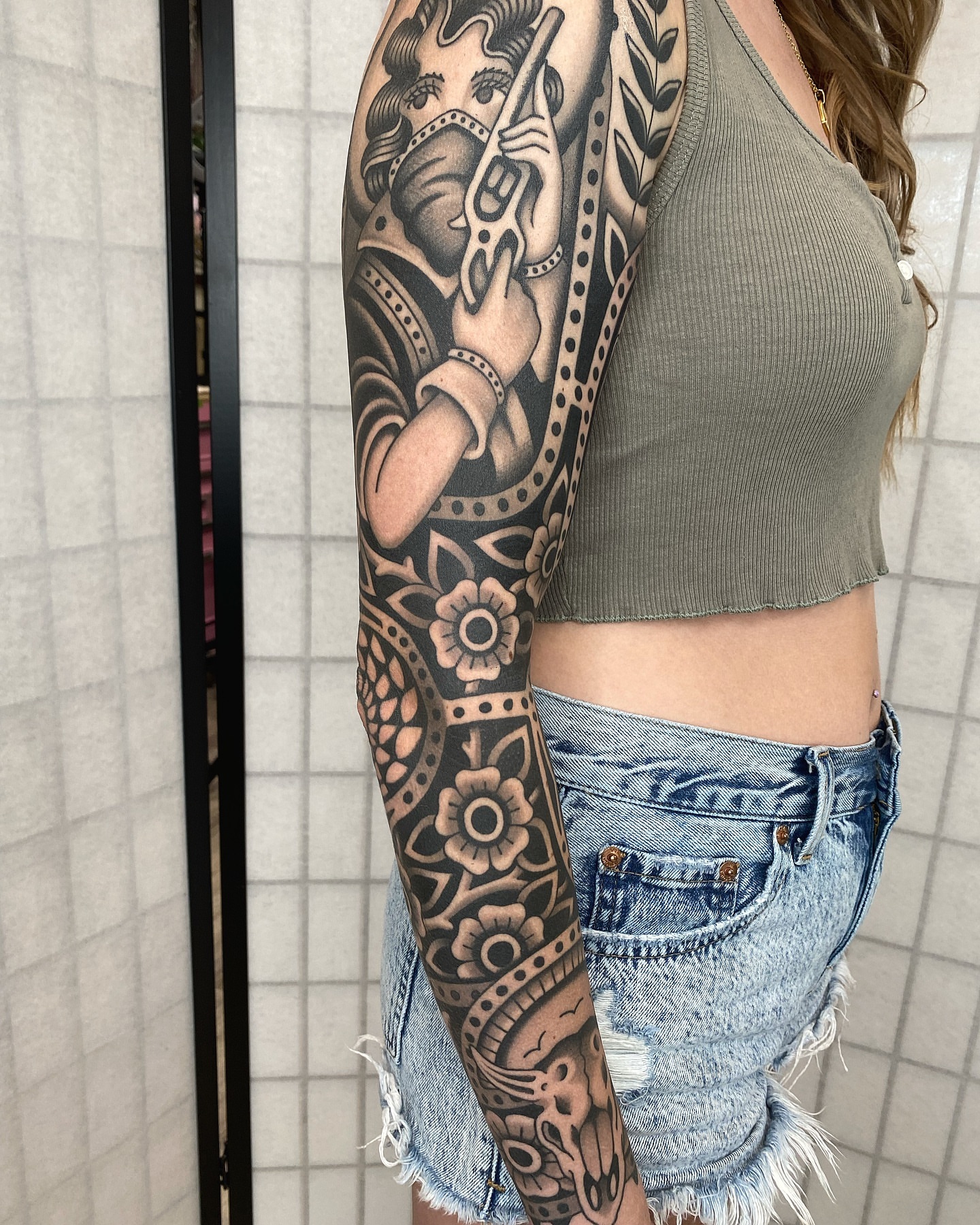 Woman with flute American traditional tattoo on the forearm by Wes Hoffman