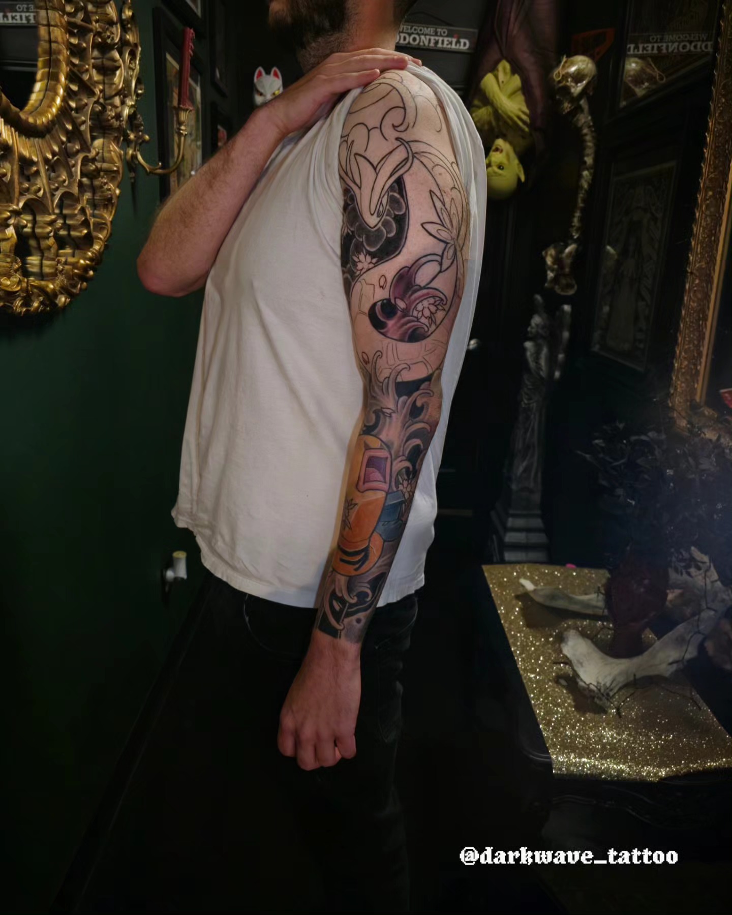 Floral and abstract American traditional tattoo on the upper arm by Barrett Handel