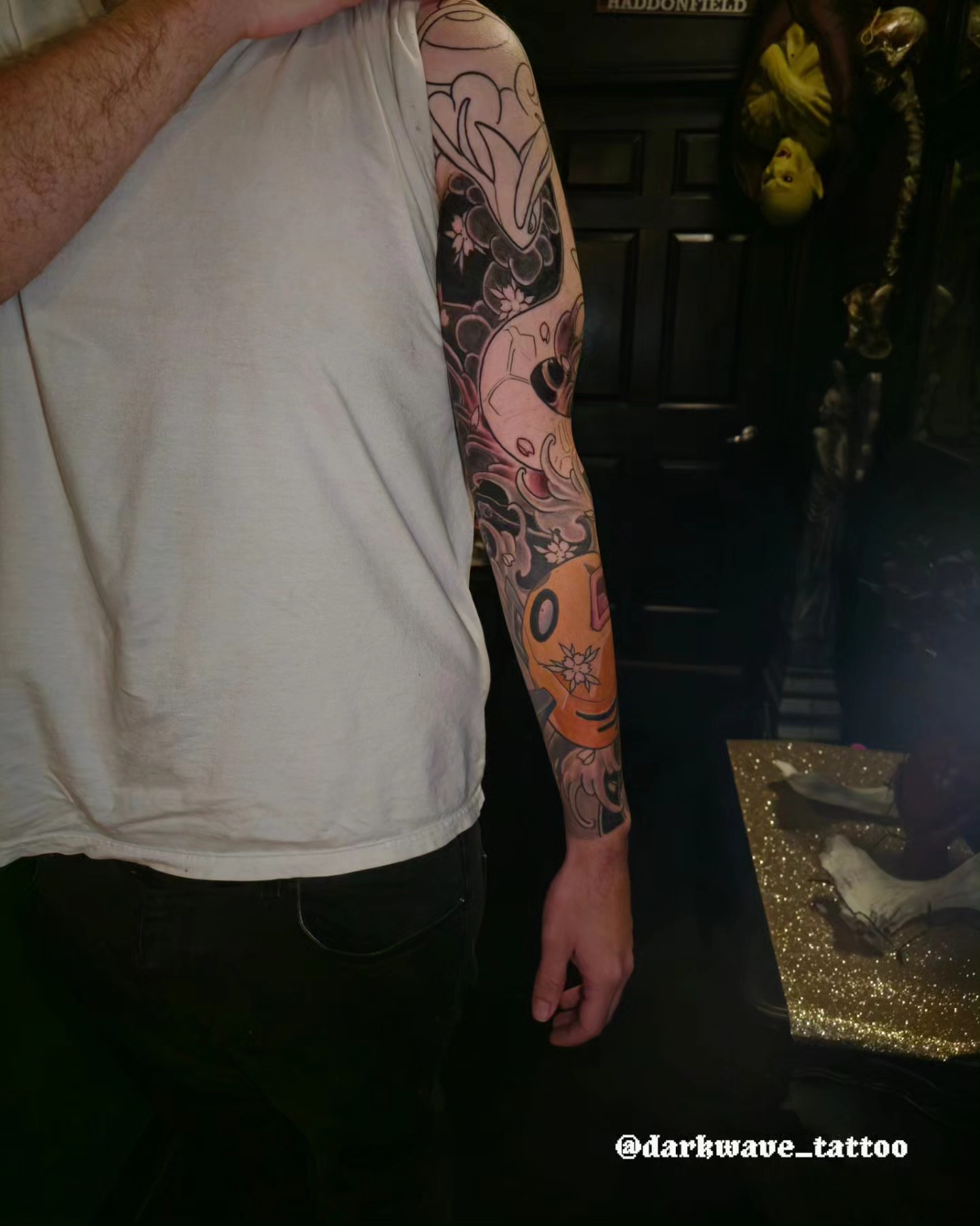 Skull and floral American traditional tattoo on the forearm by Barrett Handel
