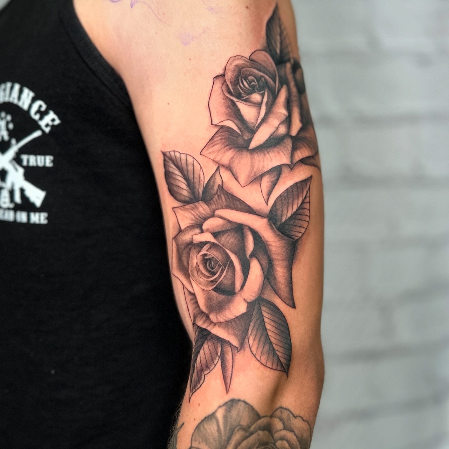 Roses black and grey tattoo on the forearm by Stephen Hansen