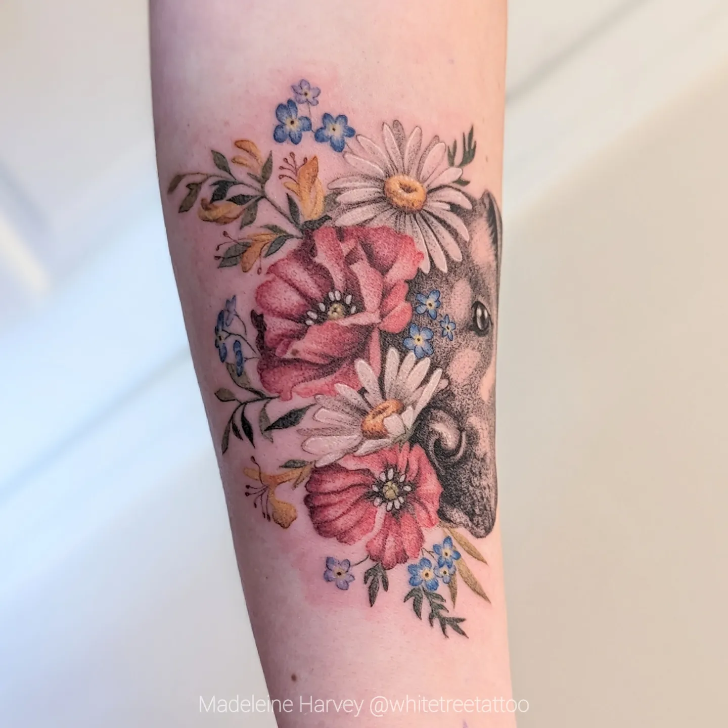 Elephant and floral bouquet dotwork tattoo on the forearm by Maddie