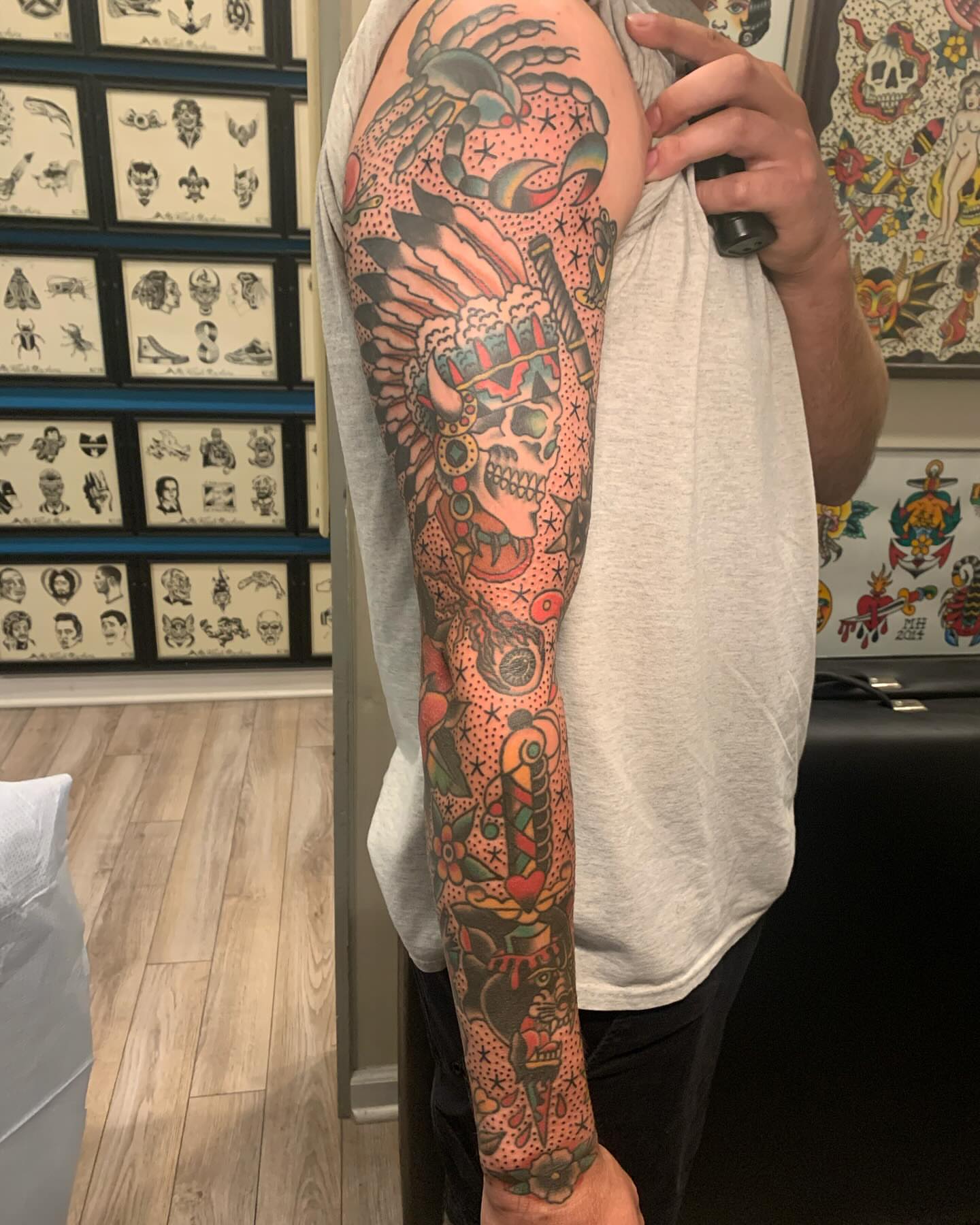 Skull and feathers American traditional tattoo on the forearm by mike_howard