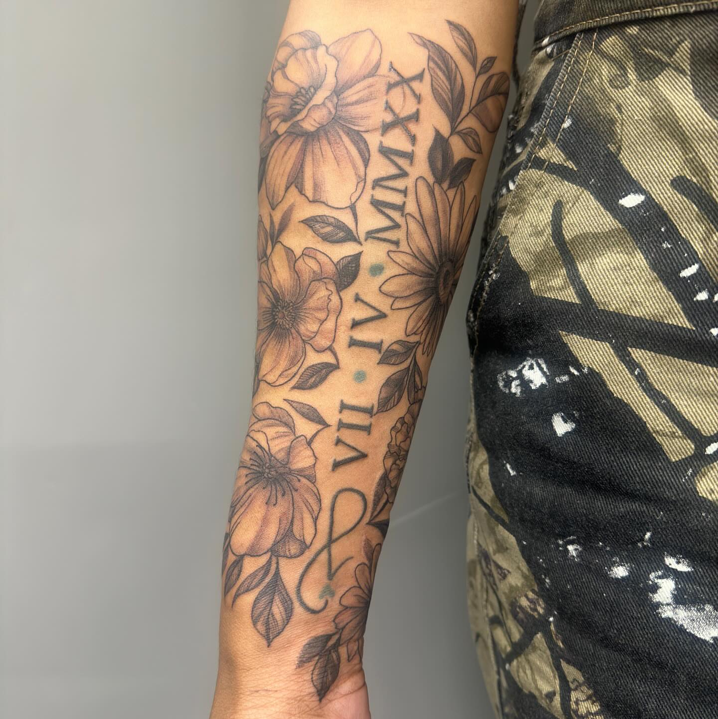 Floral arrangement black and grey tattoo on the forearm by Detroit Tattoo Artist