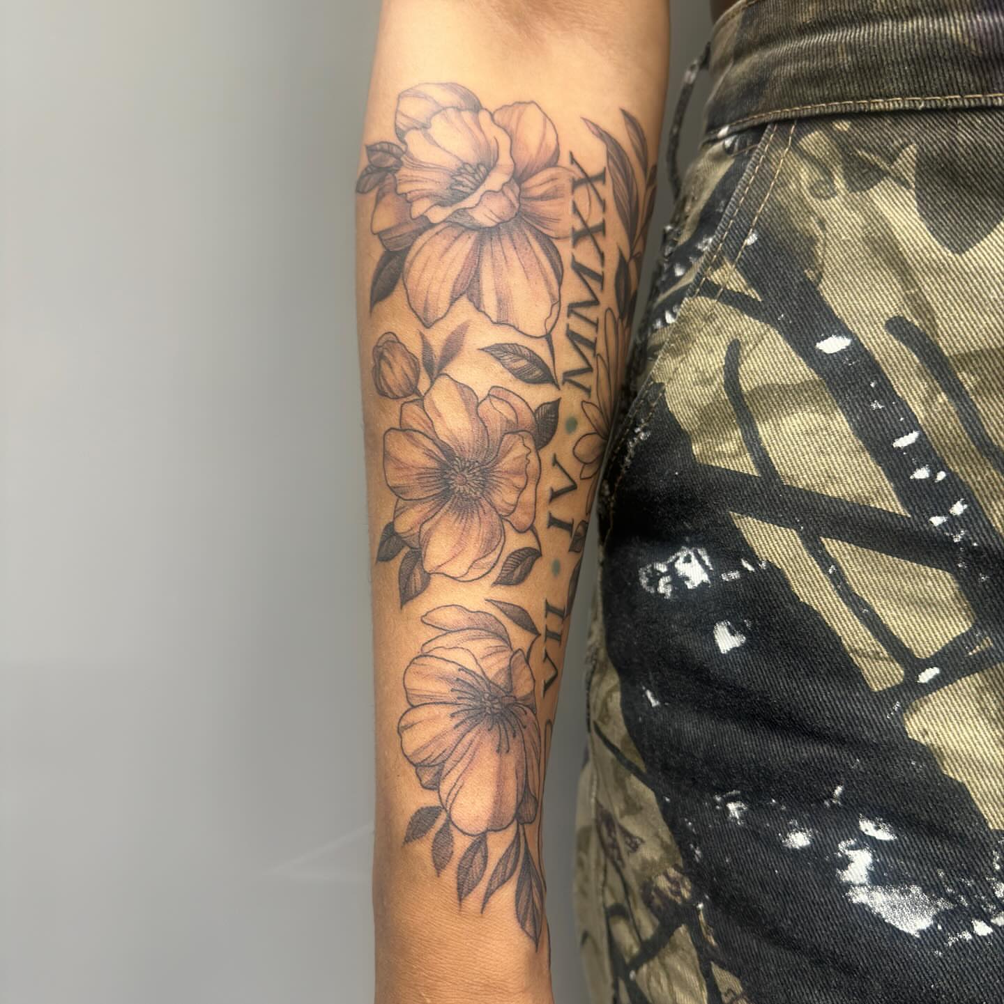Floral arrangement black and grey tattoo on the forearm by Detroit Tattoo Artist