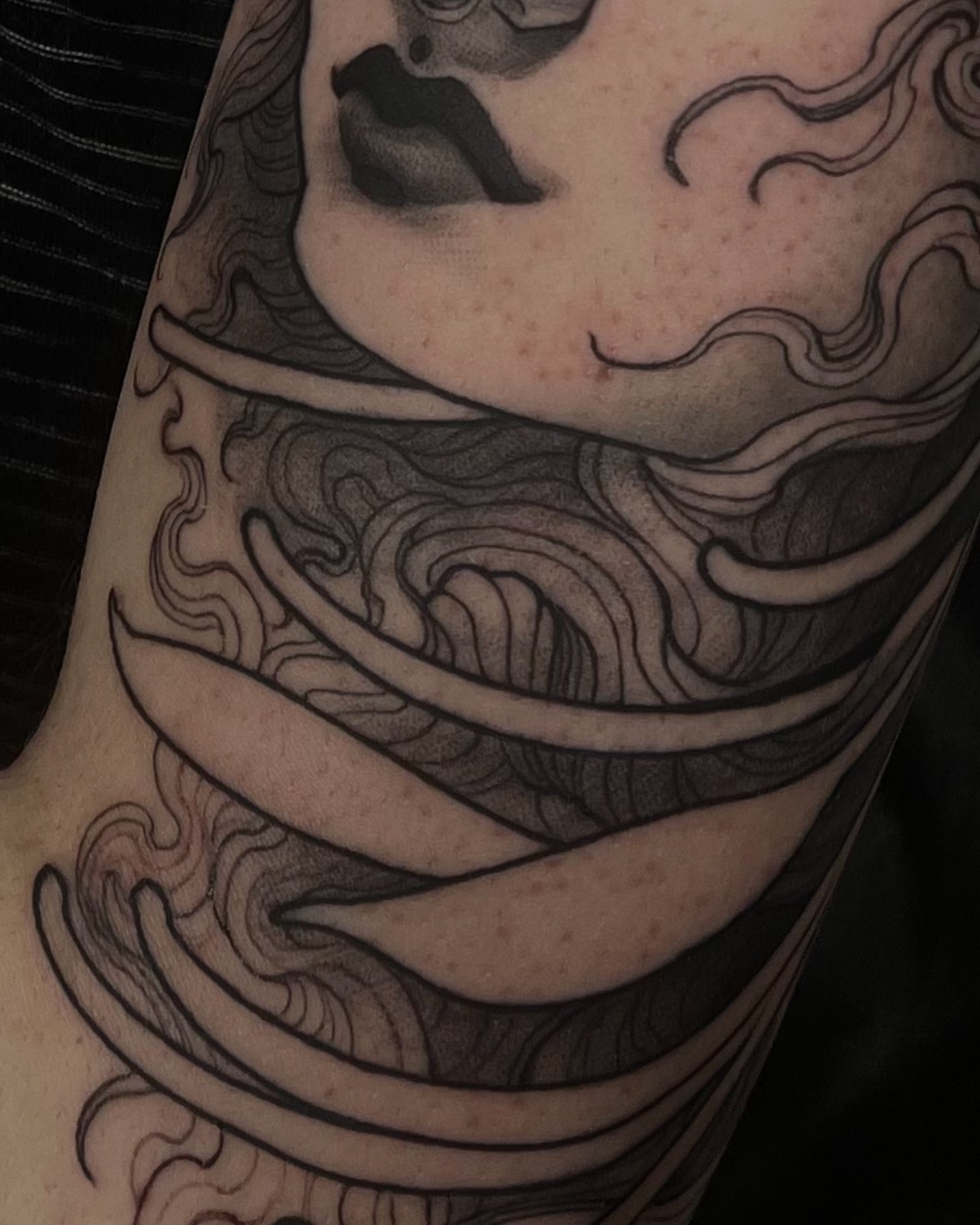 Woman's face black and grey tattoo on the forearm by Madison Ast Tattoo