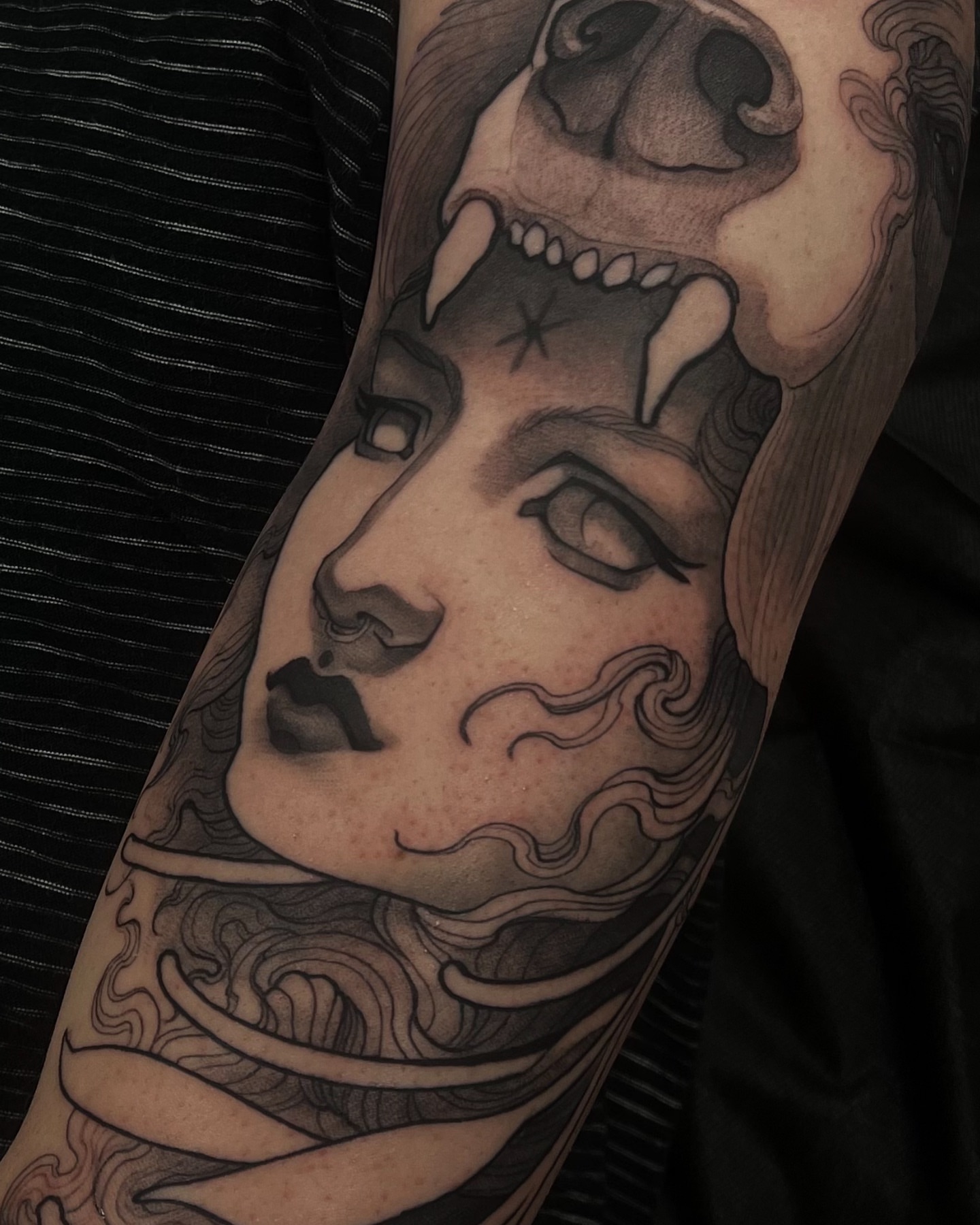 Woman's face with skull realism tattoo on the forearm by Madison Ast Tattoo