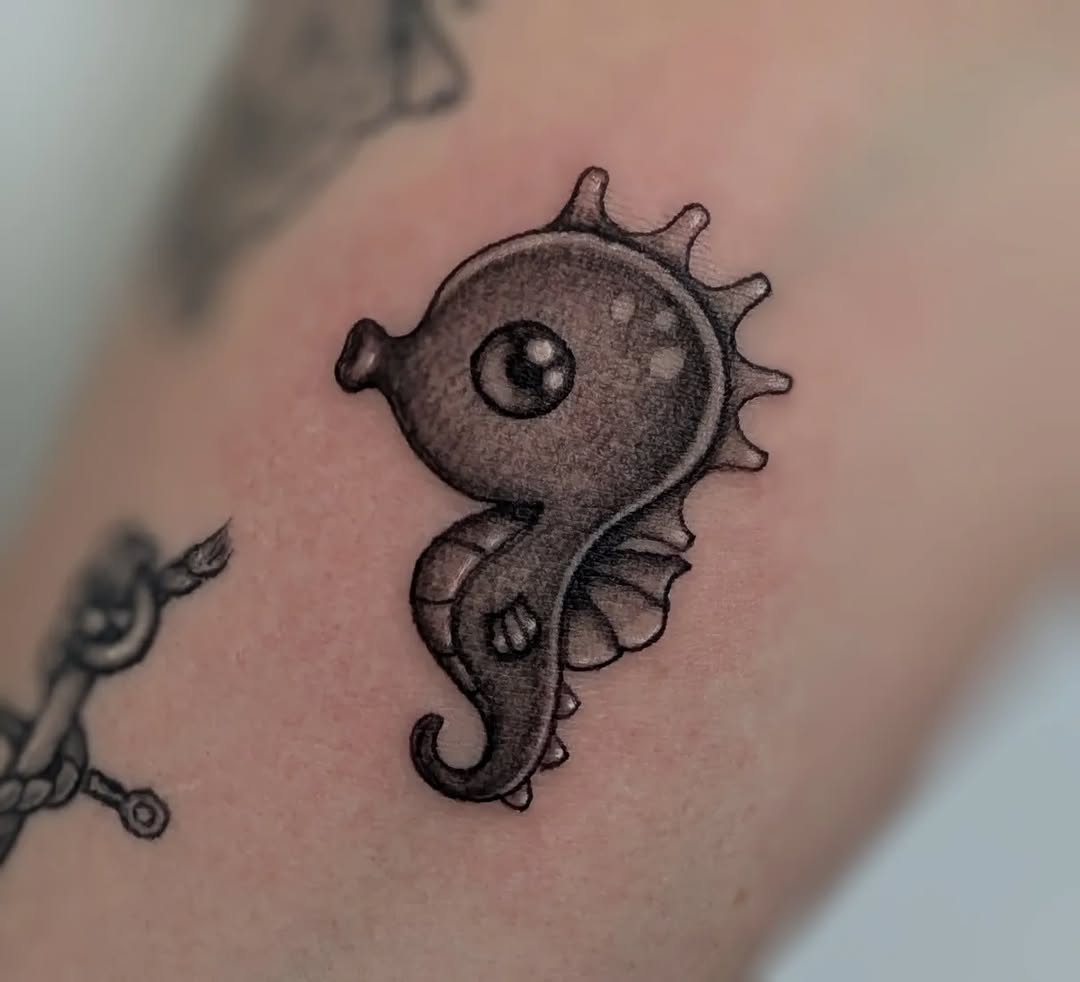 Seahorse fine line tattoo on the forearm by Deborah