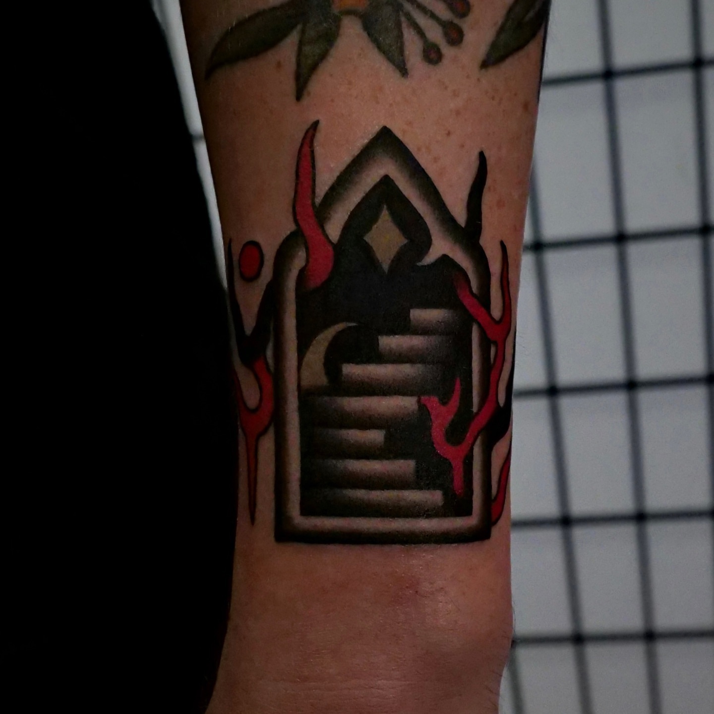 Staircase with flames American traditional tattoo on the forearm by Brandon Murphy