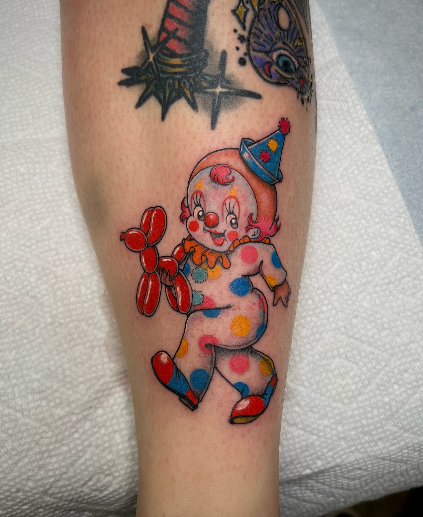 Clown with balloon American traditional tattoo on the forearm by Valerie Dominguez