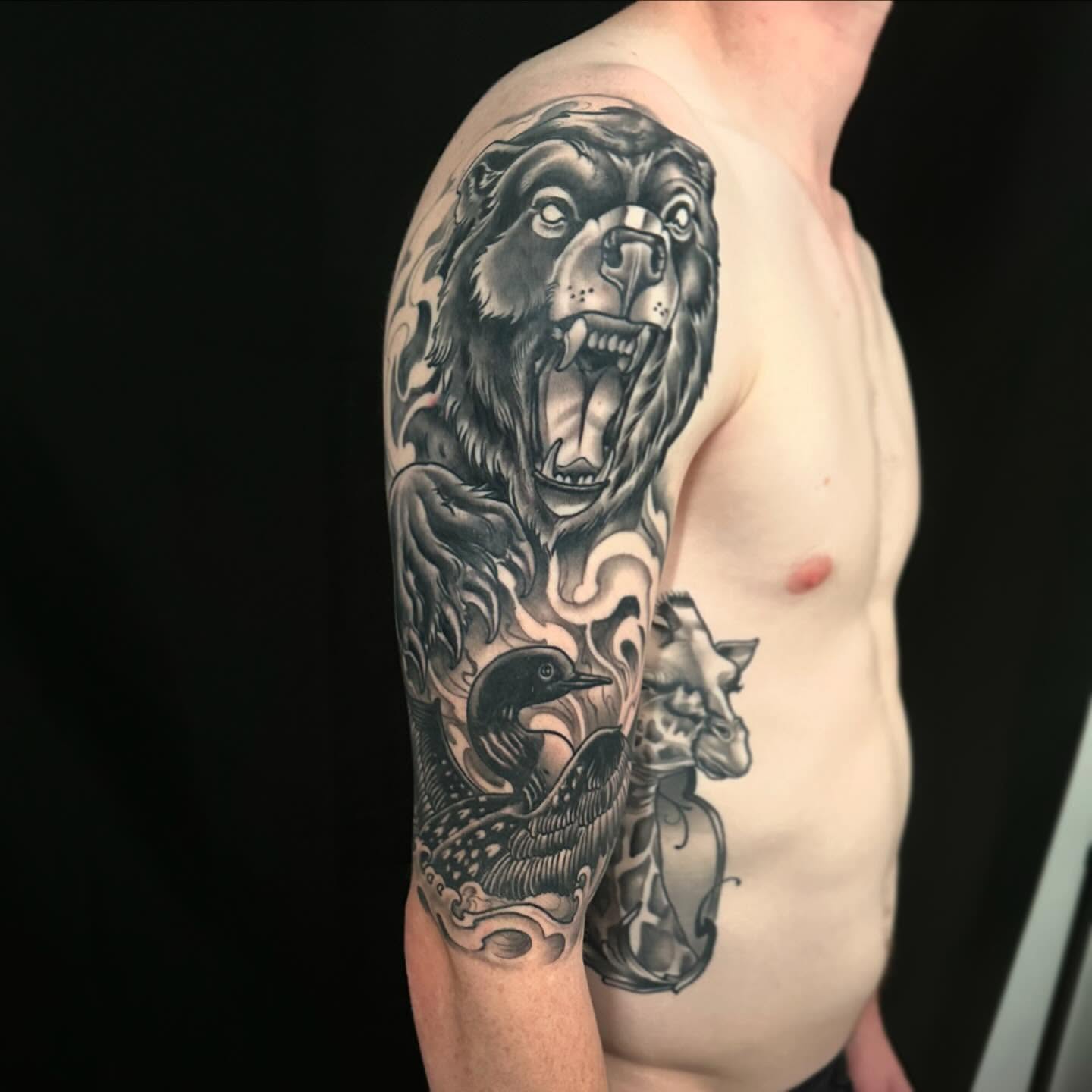 Roaring bear realism tattoo on the upper arm by John Milosh Chamberlin