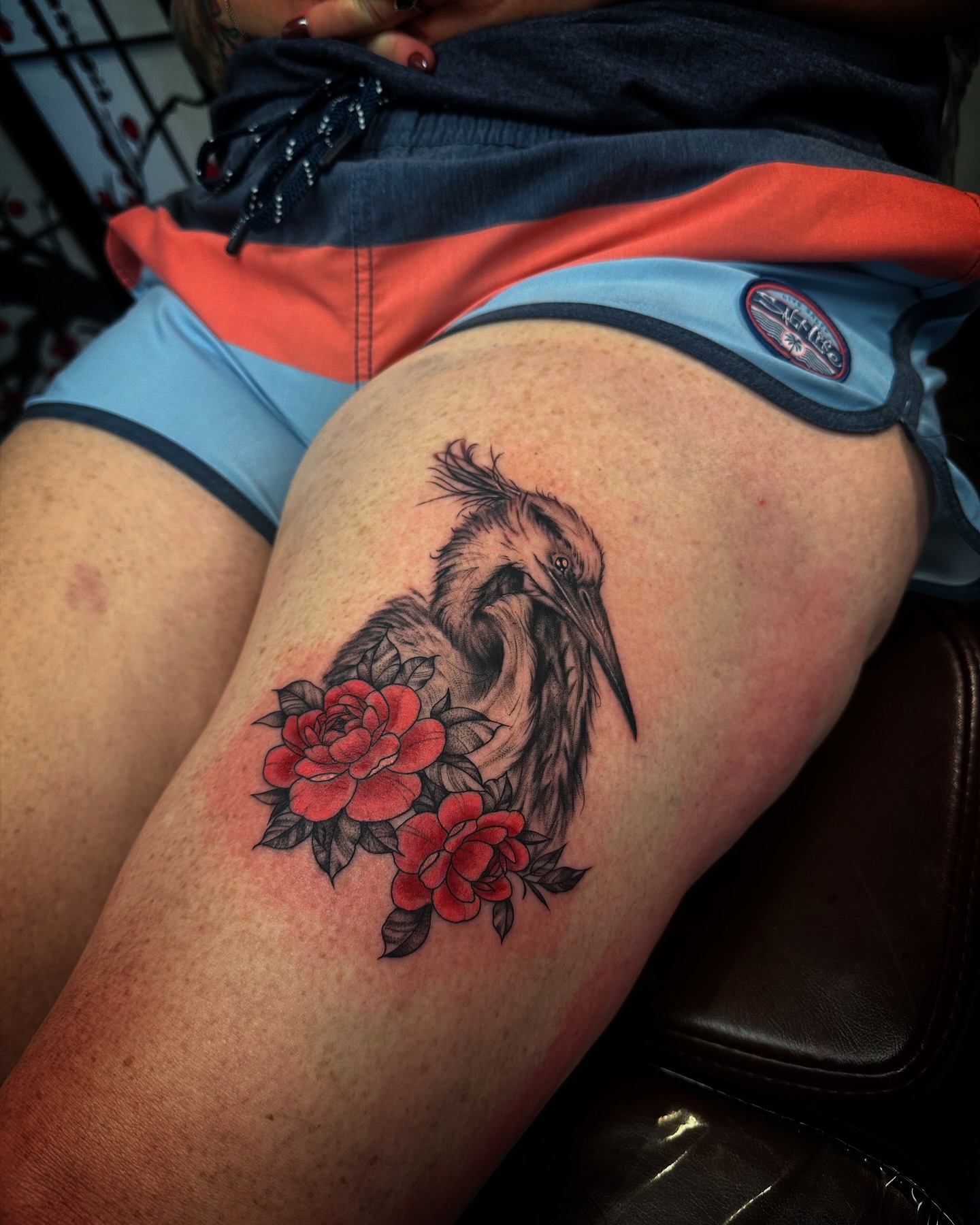Heron with roses realism tattoo on the thigh by Kassie Perian