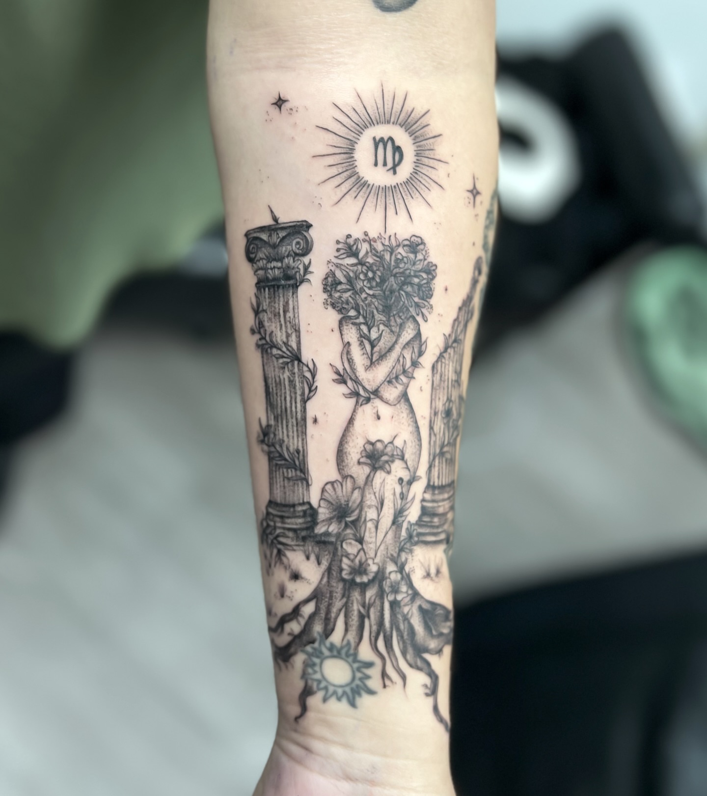 Naked woman with flowers realism tattoo on the forearm by Syd Cheyenne