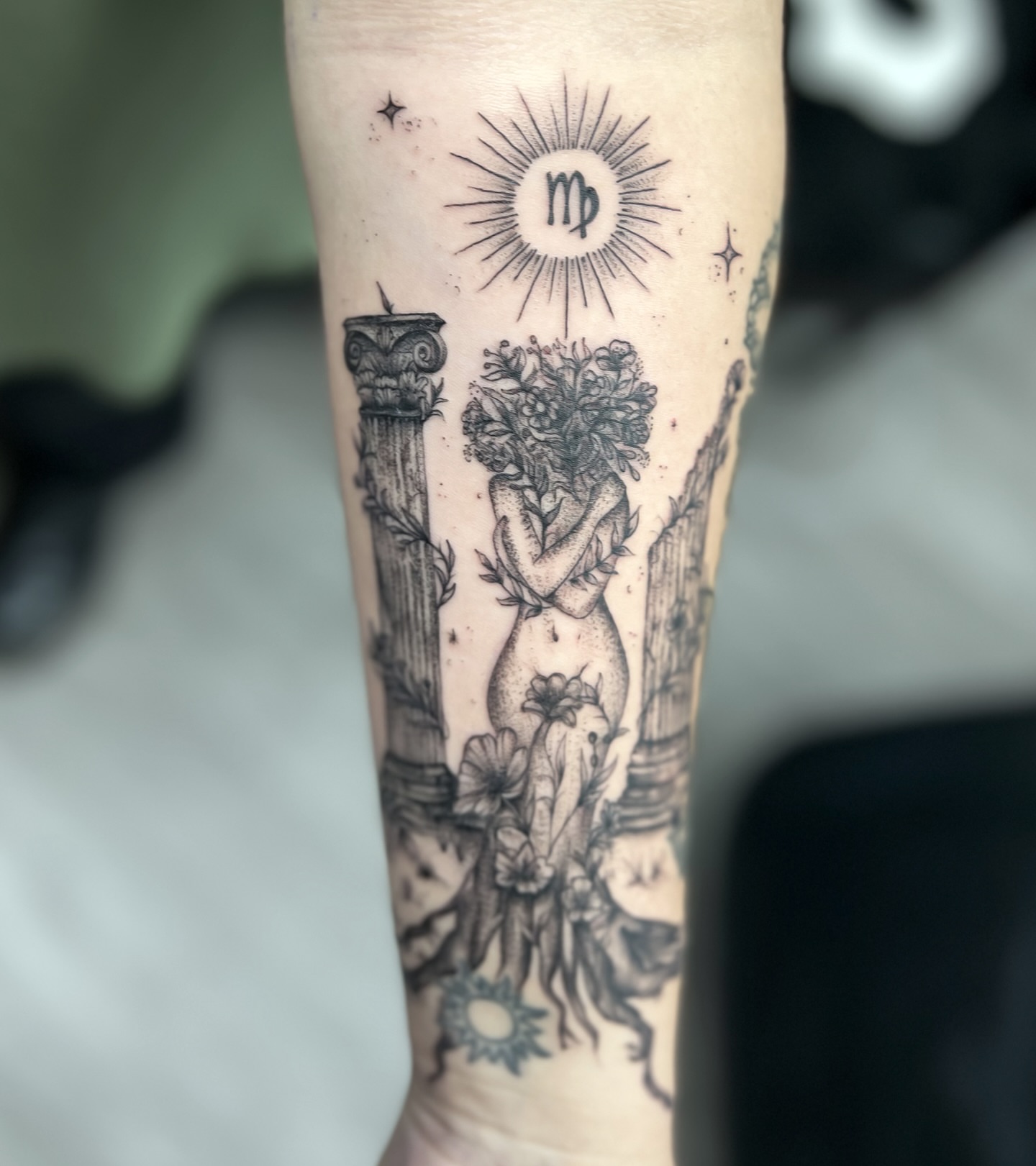 Astronomical symbol and floral figure realism tattoo on the forearm by Syd Cheyenne