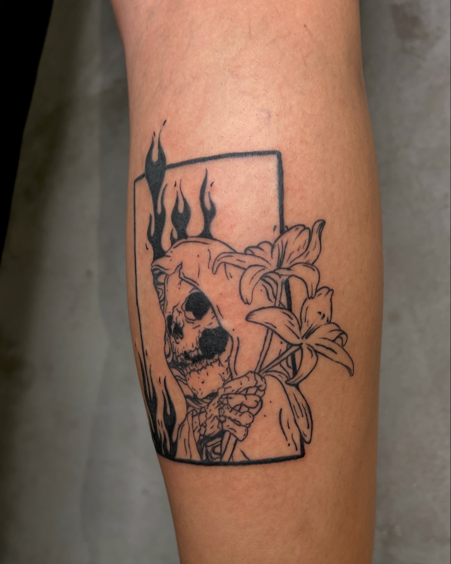 Skull and lilies black and grey tattoo on the forearm by Rebel milly Tattoo