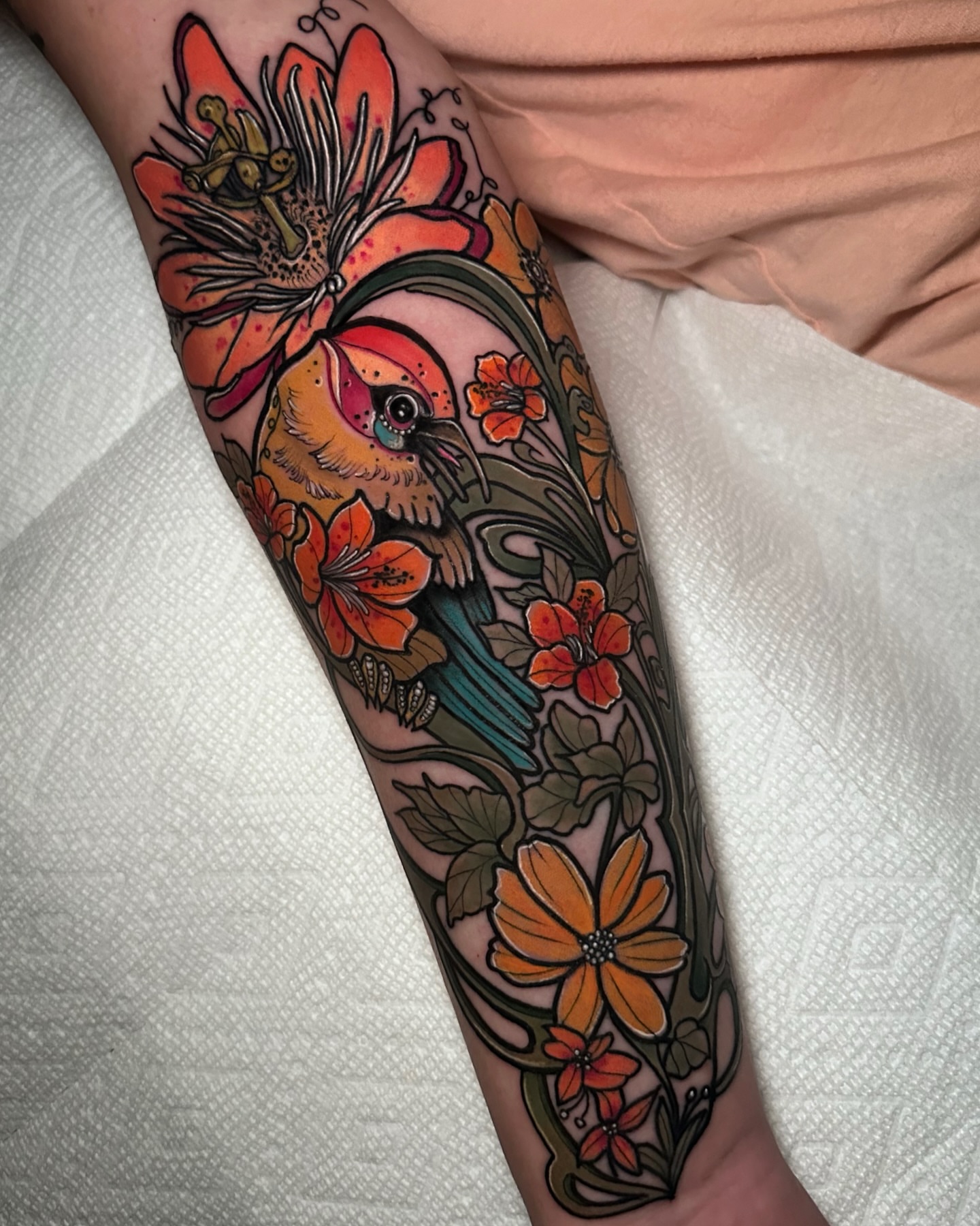 Bird and flowers American traditional tattoo on the forearm by Naysla Droguett