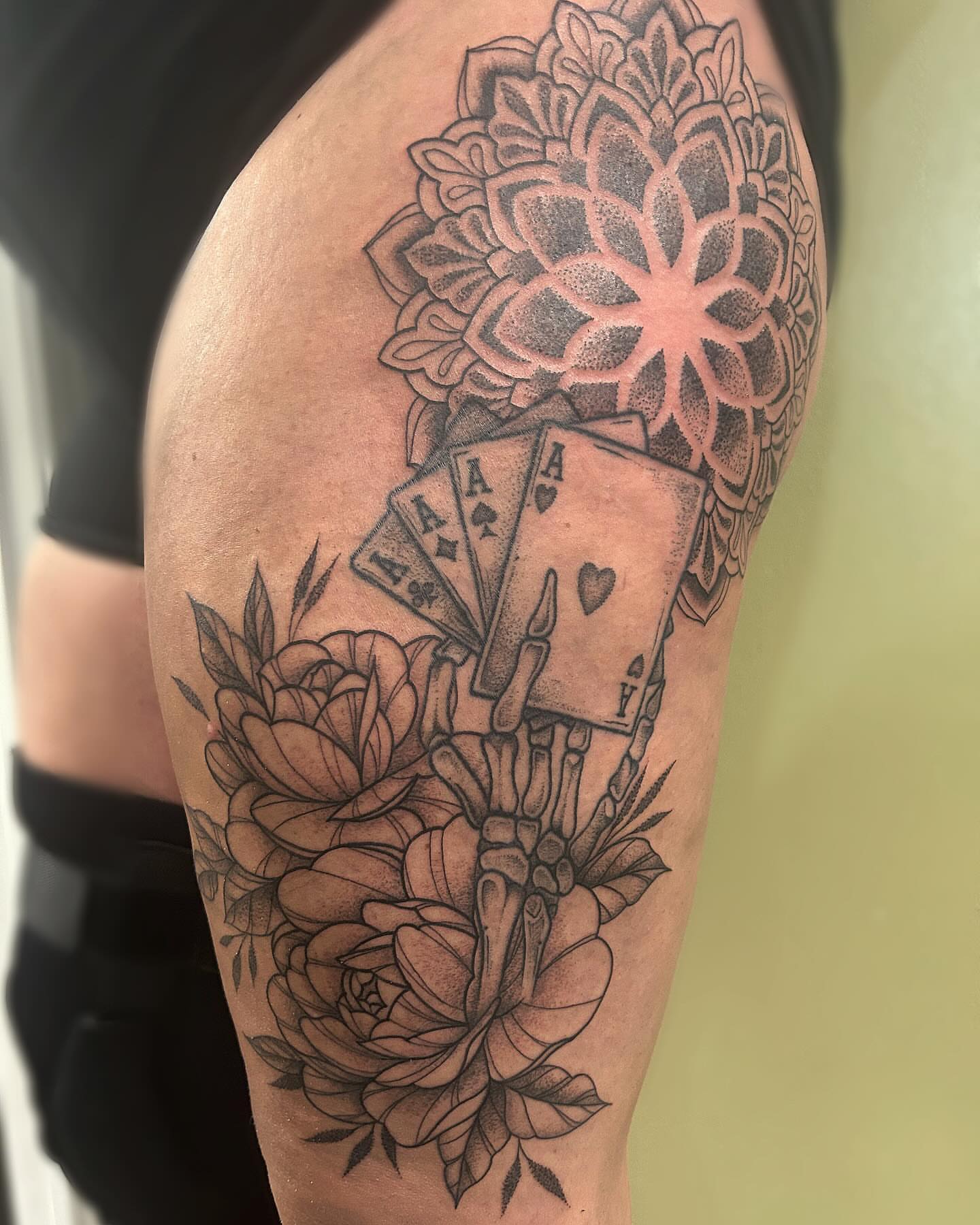 Playing cards and flowers dotwork tattoo on the upper arm by ππππππ ππππππ