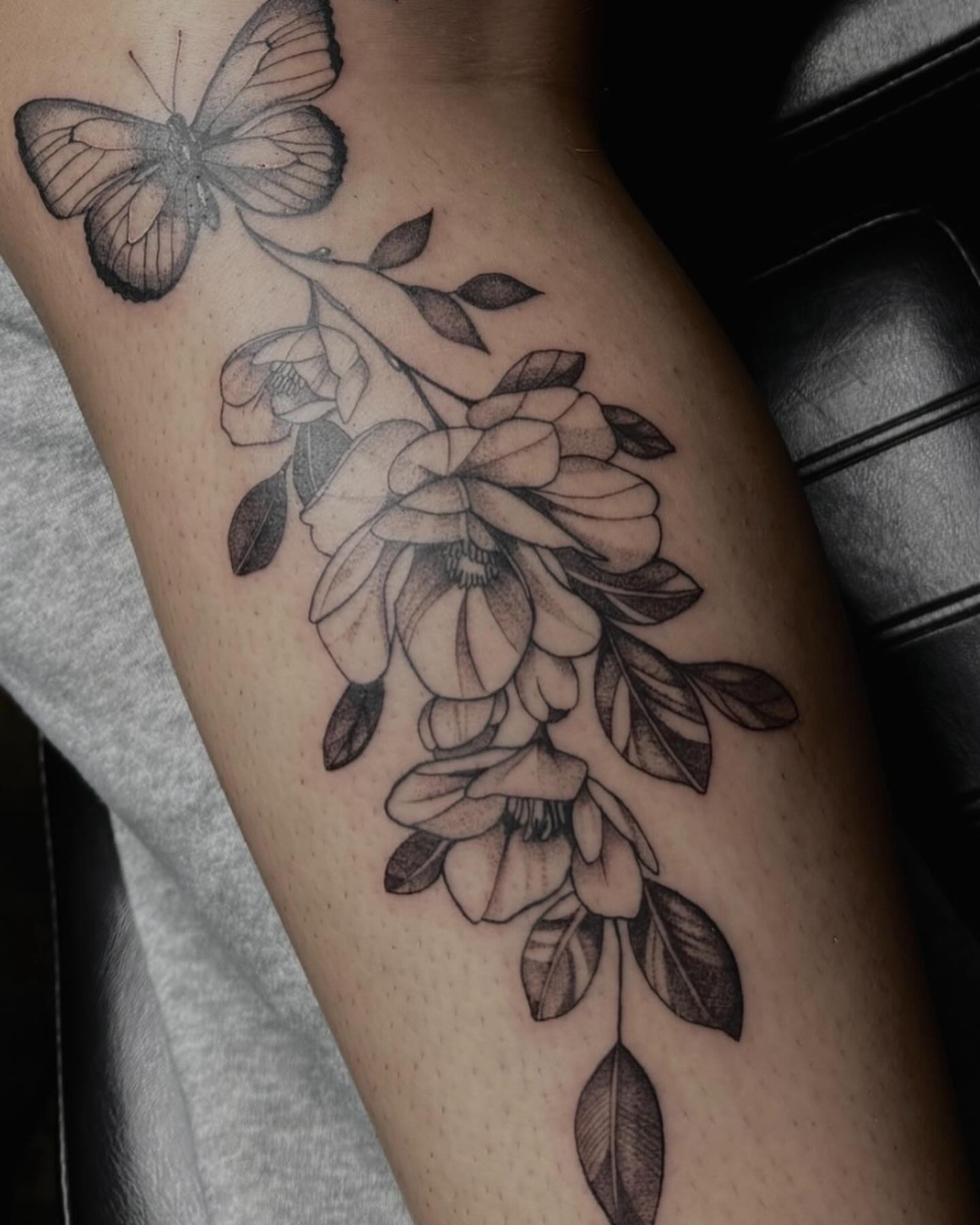 Wisteria and butterfly realism tattoo on the forearm by V