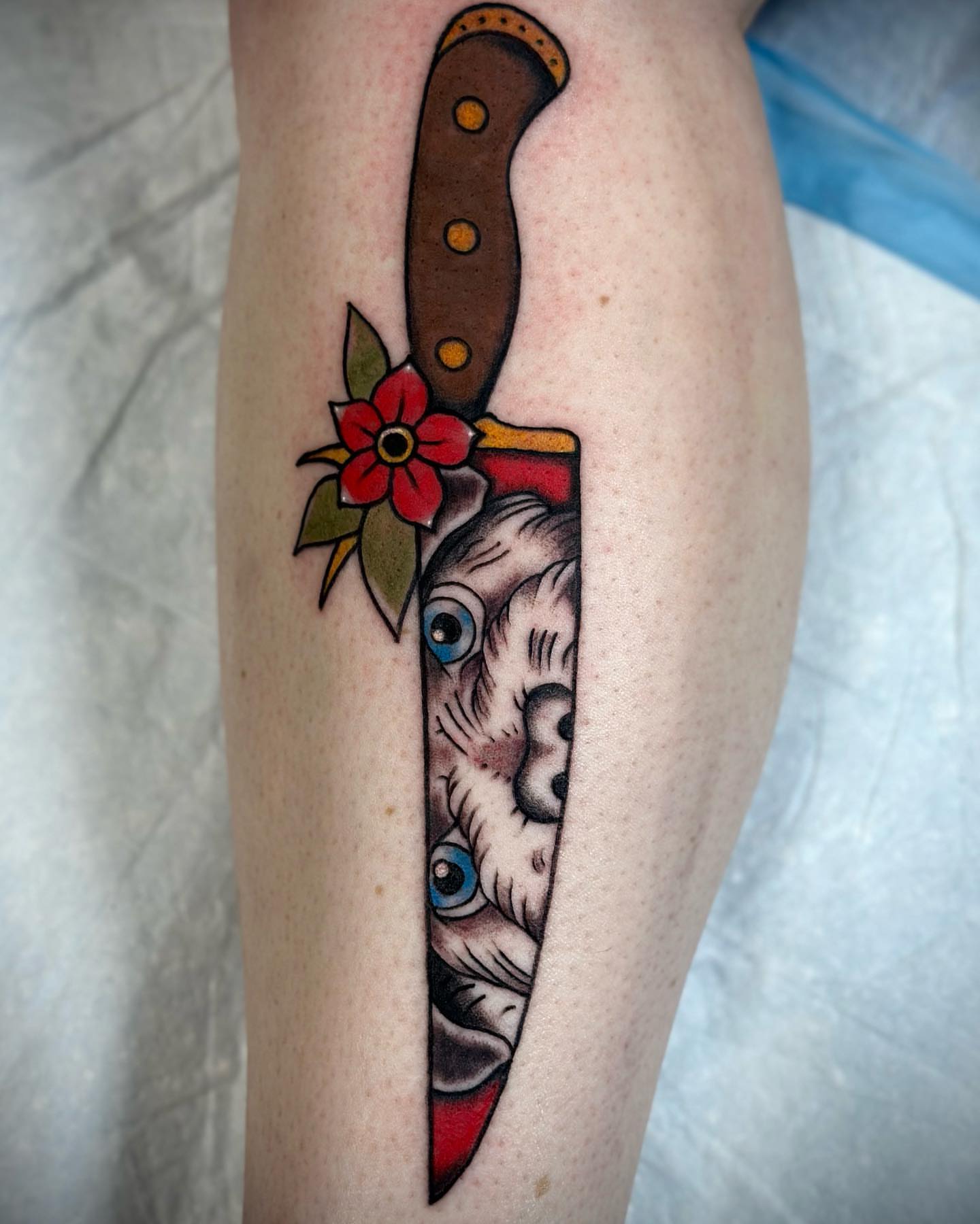 Cat knife American traditional tattoo on the forearm by Olive Kelley