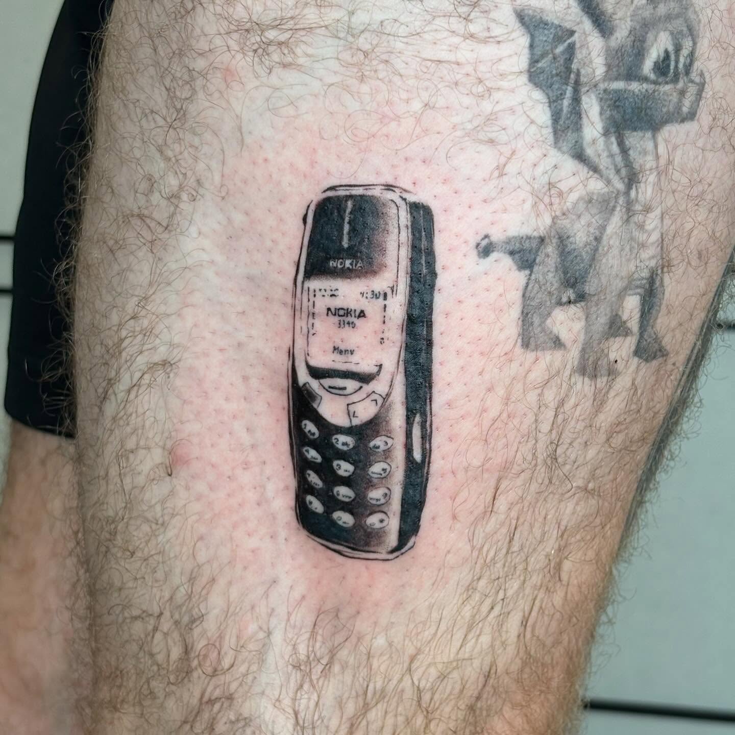 Nokia phone realism tattoo on the leg by sanjai