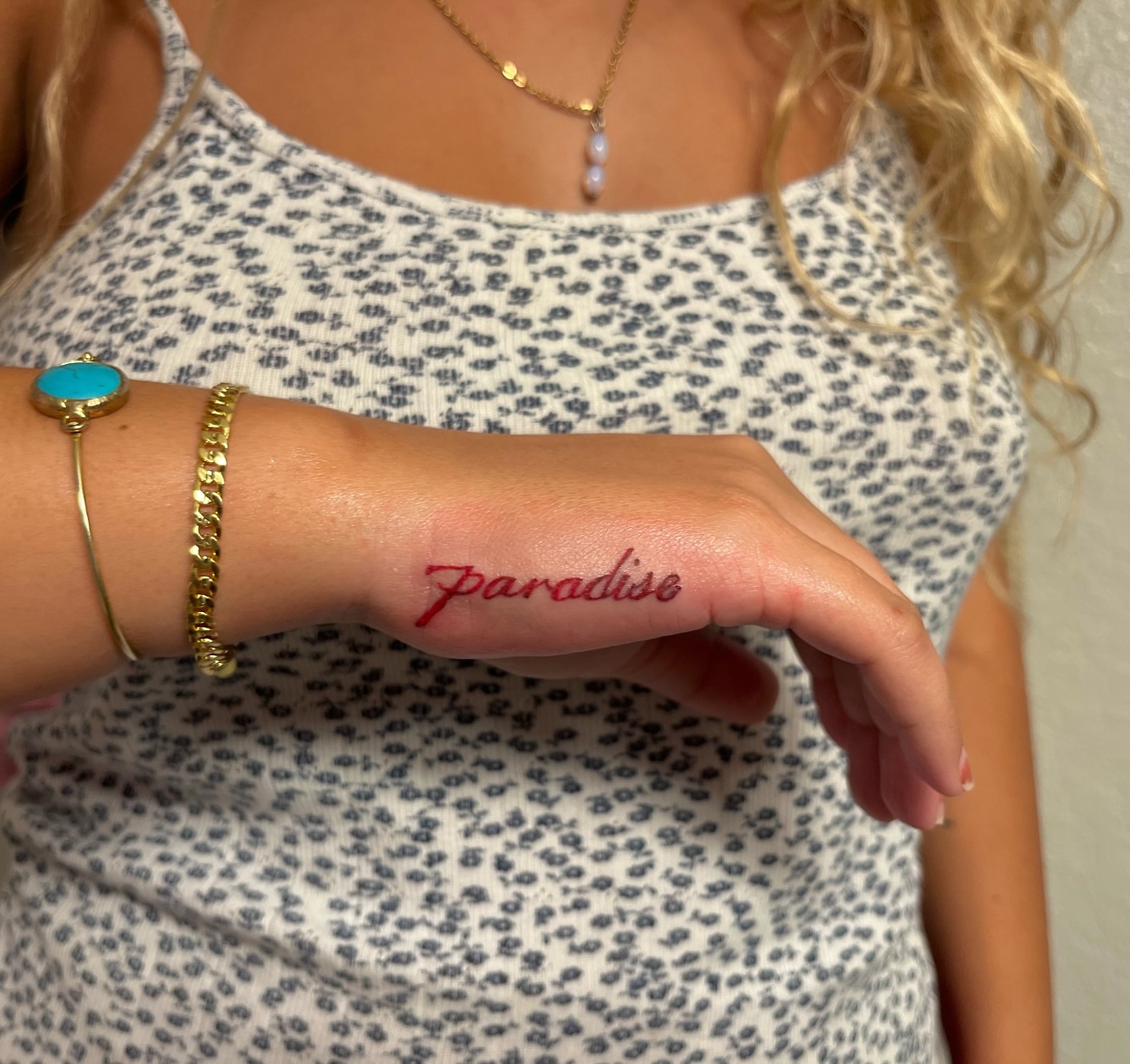 Paradise lettering script tattoo on the hand by miranda