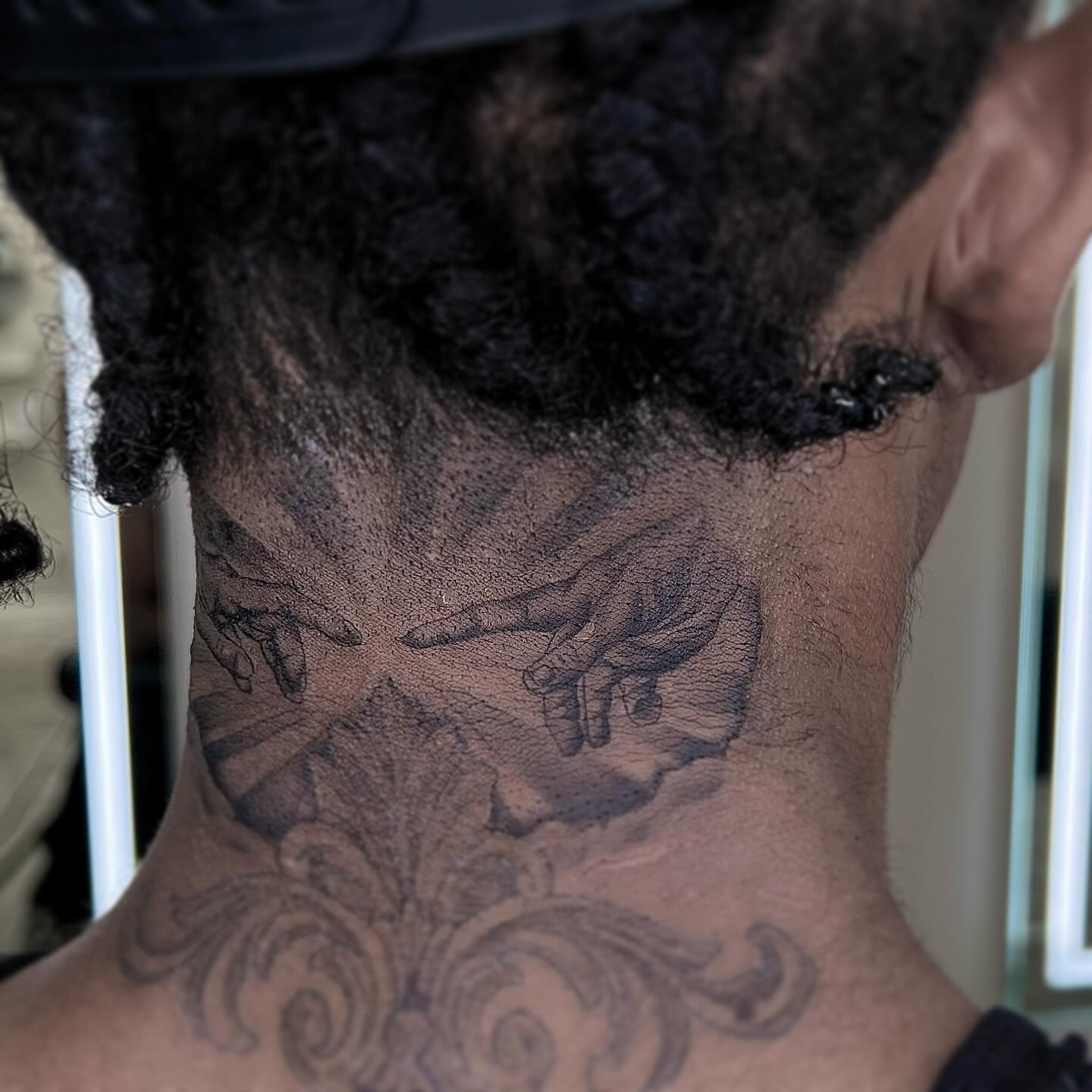 Hands and floral black and grey tattoo on the neck by Jocelyn