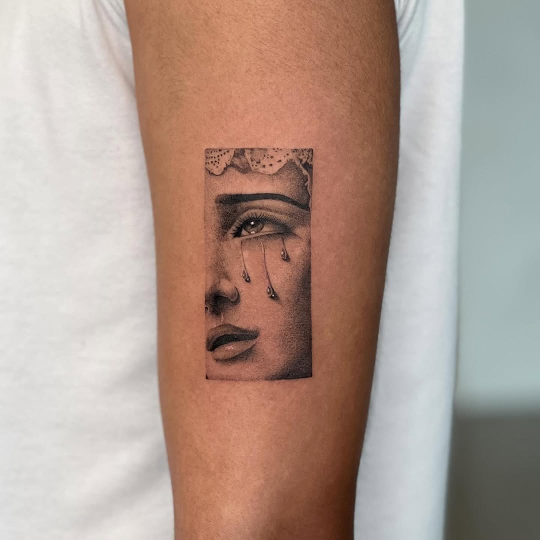 Crying face surrealism tattoo on the forearm by Miami Tattoo Artist, Miami, Florida