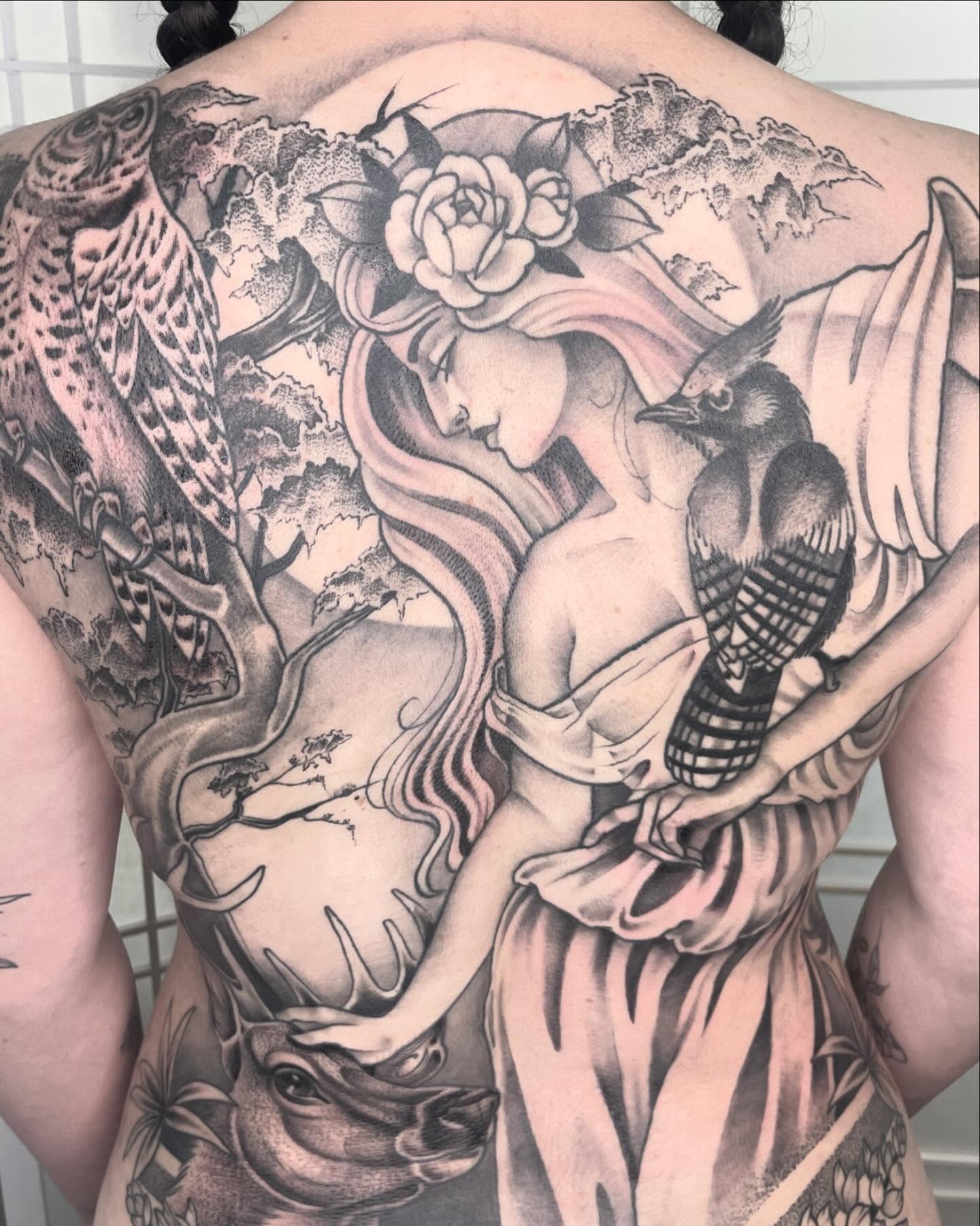 Woman with bird realism tattoo on the back by Amanda Marie, Edmonds, Washington